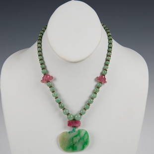 Chinese Jadeite and Tourmaline Bead Necklace with Pendant: A fine Chinese jadeite bead necklace, comprised of three pink tourmaline beads surrounded by jadeite beads of graduating size with metal working. Hung with matching jadeite pendant with floral motif;