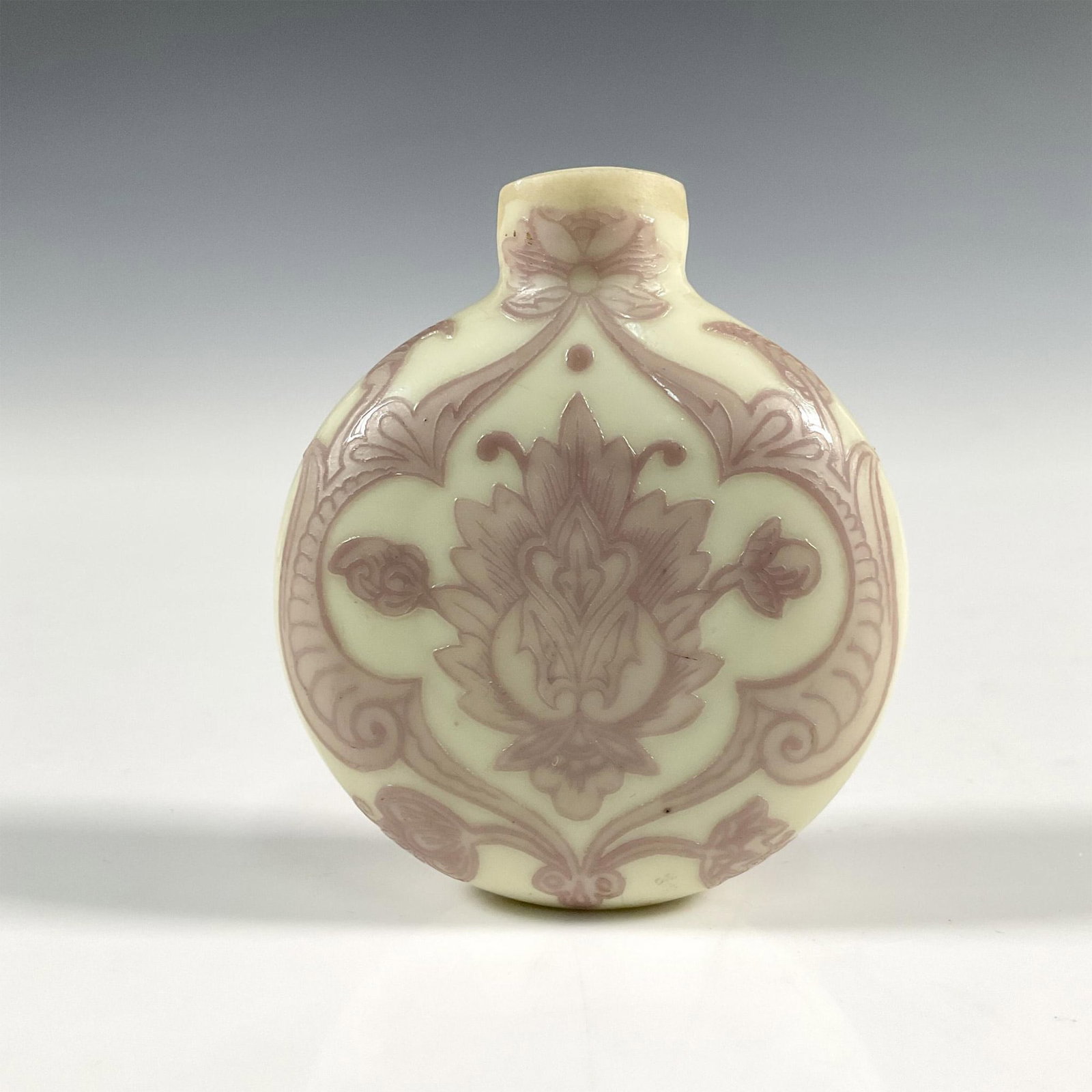Early Chinese Glass Moon Shaped Snuff Bottle: A Chinese glass snuff bottle, beautiful decorations of pink enamel lotus design; flat foot. Wide mouth without stopper. Dimensions: 2"L x 1"W x 2.25"H Country of Origin: China
