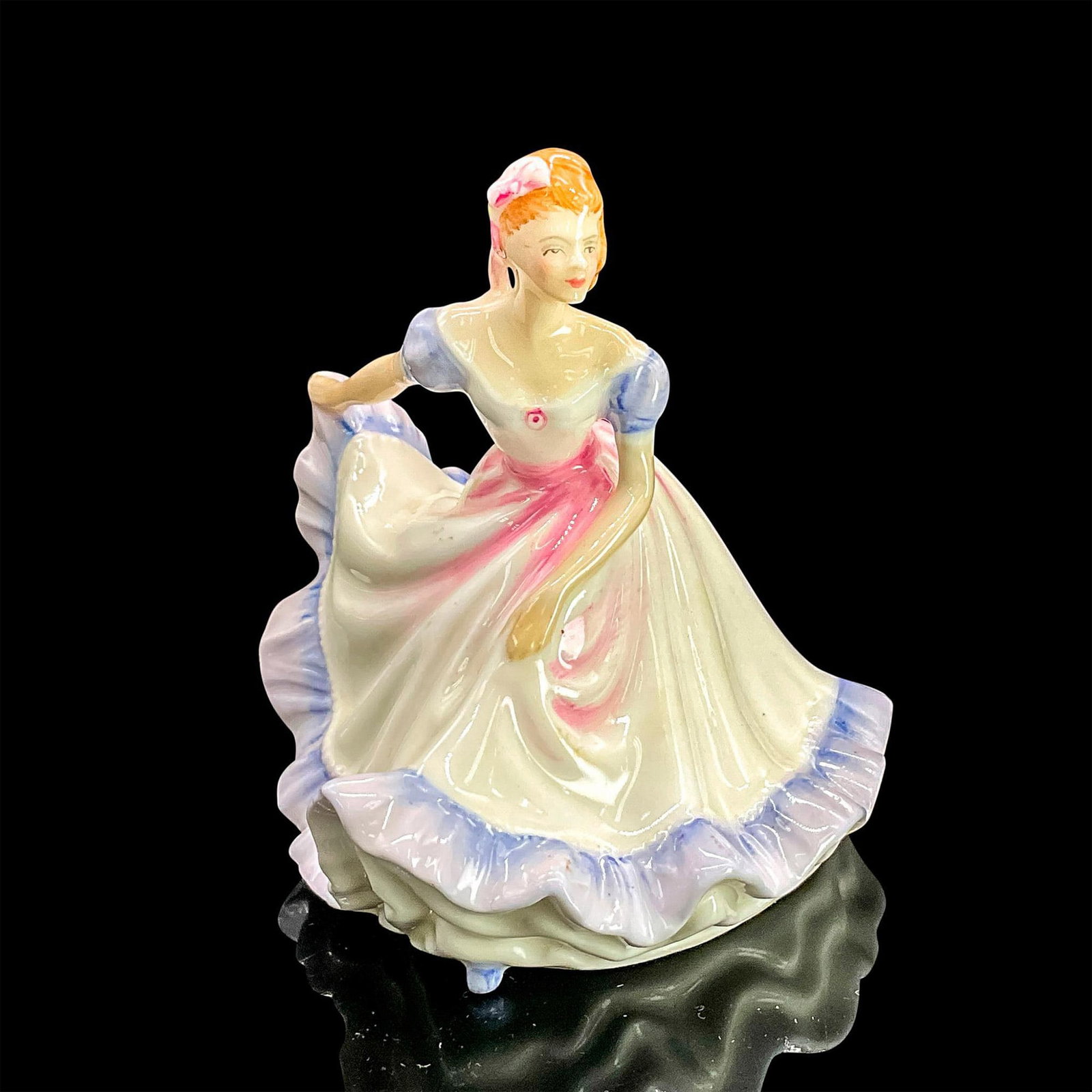 Ninette HN3215 - Royal Doulton Figurine: Glazed bone china figure of lady in a white dress with purple ruffle trim and sleeves, pink accents and hair bow. Part of the Miniatures series. Royal Doulton backstamp. Artist: Peggy Davies Dimension