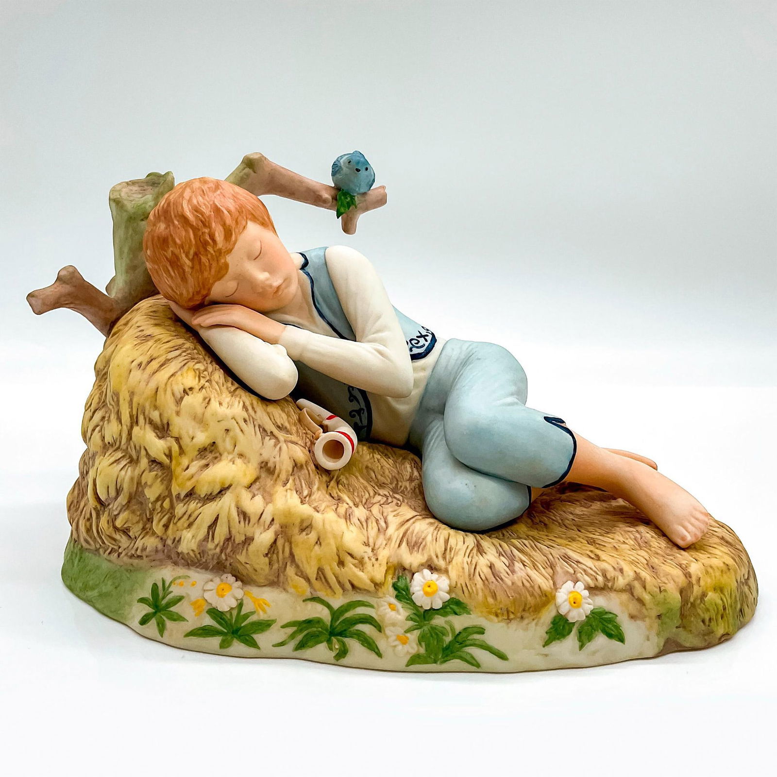 Cybis Nursery Rhyme Figurine, Little Boy Blue: Matte finish, beautiful porcelain figure of a young boy taking a nap by the haystack with his horn. Cybis mark impressed to base. Cybis hand written to back of figure. This item has no reserve. Issued