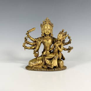 Nepalese Gilt Bronze Figure of Indian Goddess Durga: 18th century, small statue of multi armed and head goddess holding the tools of man, with separated goddess figure seated. Issued: 18th c. Dimensions: 6.5"L x 4"W x 6.5"H Country of Origin: India