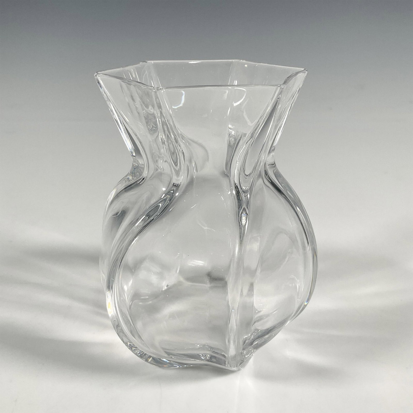 Baccarat Crystal Vase, Corolle: High-quality French crystal vase in the Corolle pattern. The vase showcases subtle twisting motion-like. Baccarat etched backstamp. Dimensions: 3.75"W x 4.75"H Manufacturer: Baccarat Country of Origin