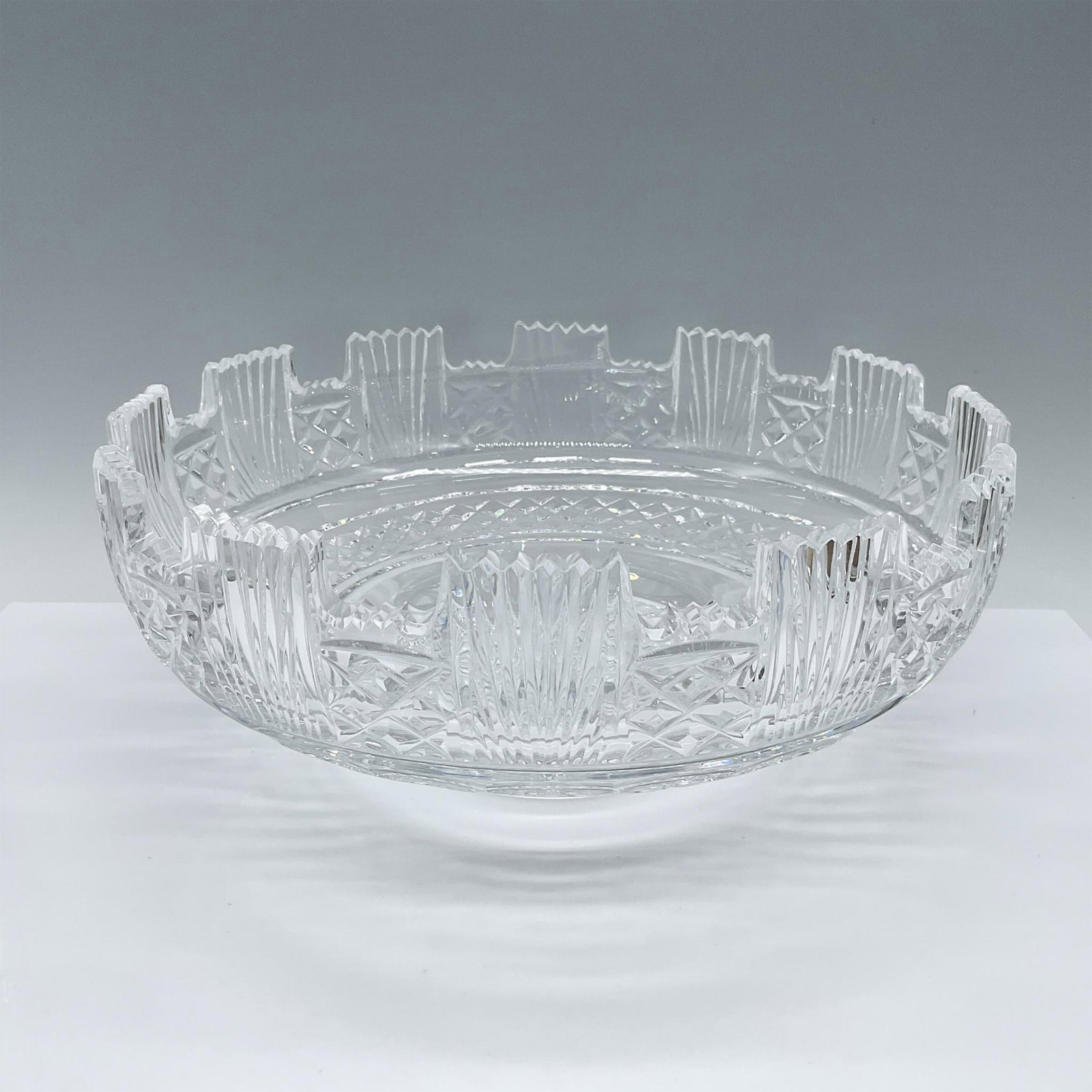 Waterford Crystal Centerpiece Bowl: Fan and trefoil cut rim above a band of cut diamonds. Star cut pontil. Waterford etched signature and stamp on base. Dimensions: 4.74"H x 11.25" dia. Manufacturer: Waterford Country of Origin: Ireland