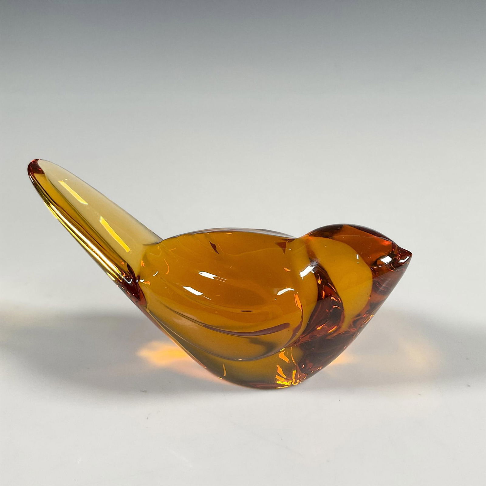 Baccarat Crystal Amber Figurine, Titi Bird: A classic Baccarat crystal figure in amber color, modeled as a loveable titi bird. Baccarat factory sticker. Baccarat backstamp. Dimensions: 1.75"L x 3.75"W x 1.75"H Manufacturer: Baccarat Country of