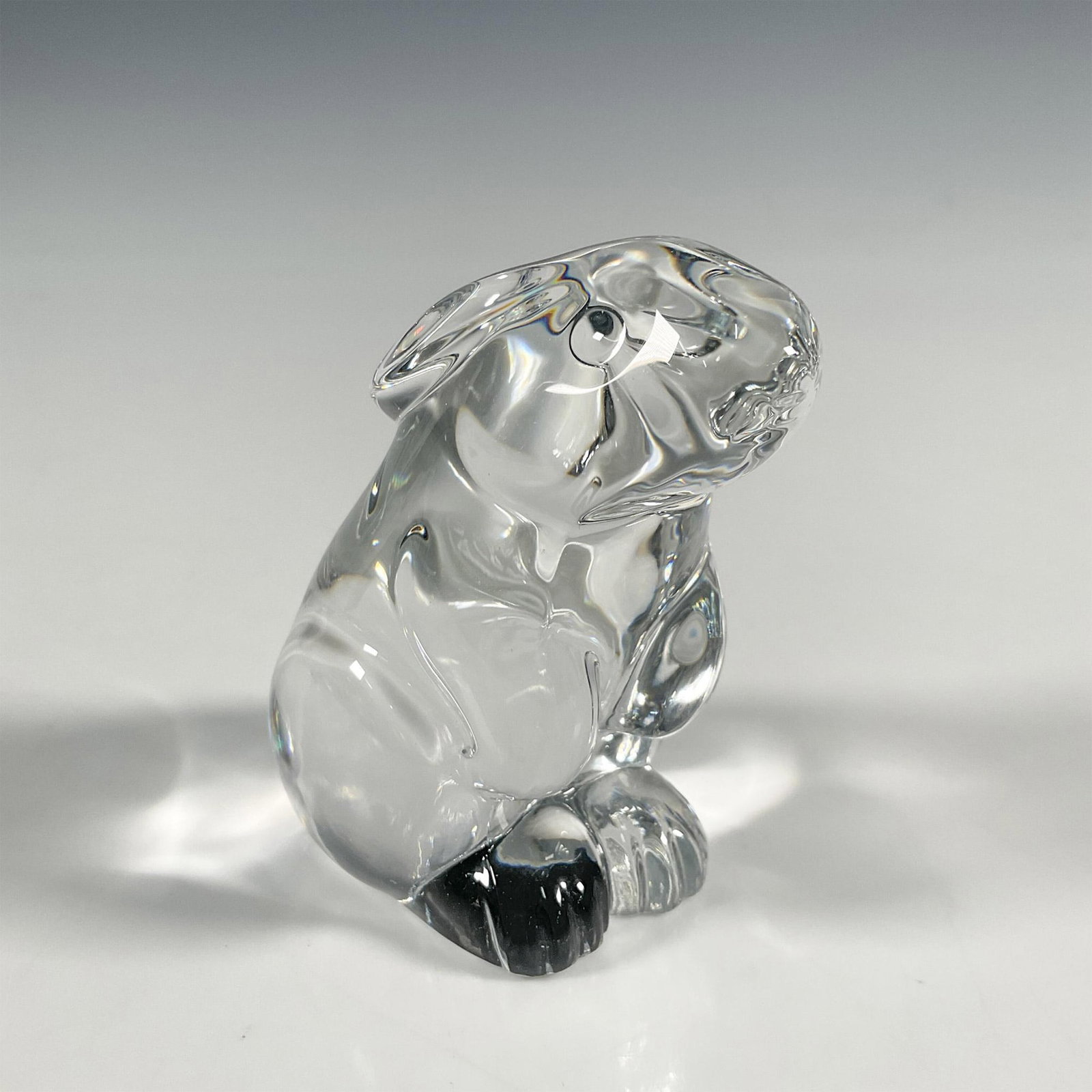 Baccarat Crystal Figurine, Rabbit: A French luxury crystal figurine, clear and adorable bunny rabbit with short ears sitting up. Baccarat backstamp. Issued: 20th c. Dimensions: 2"L x 2.75"W x 3"H Manufacturer: Baccarat Country of Origi