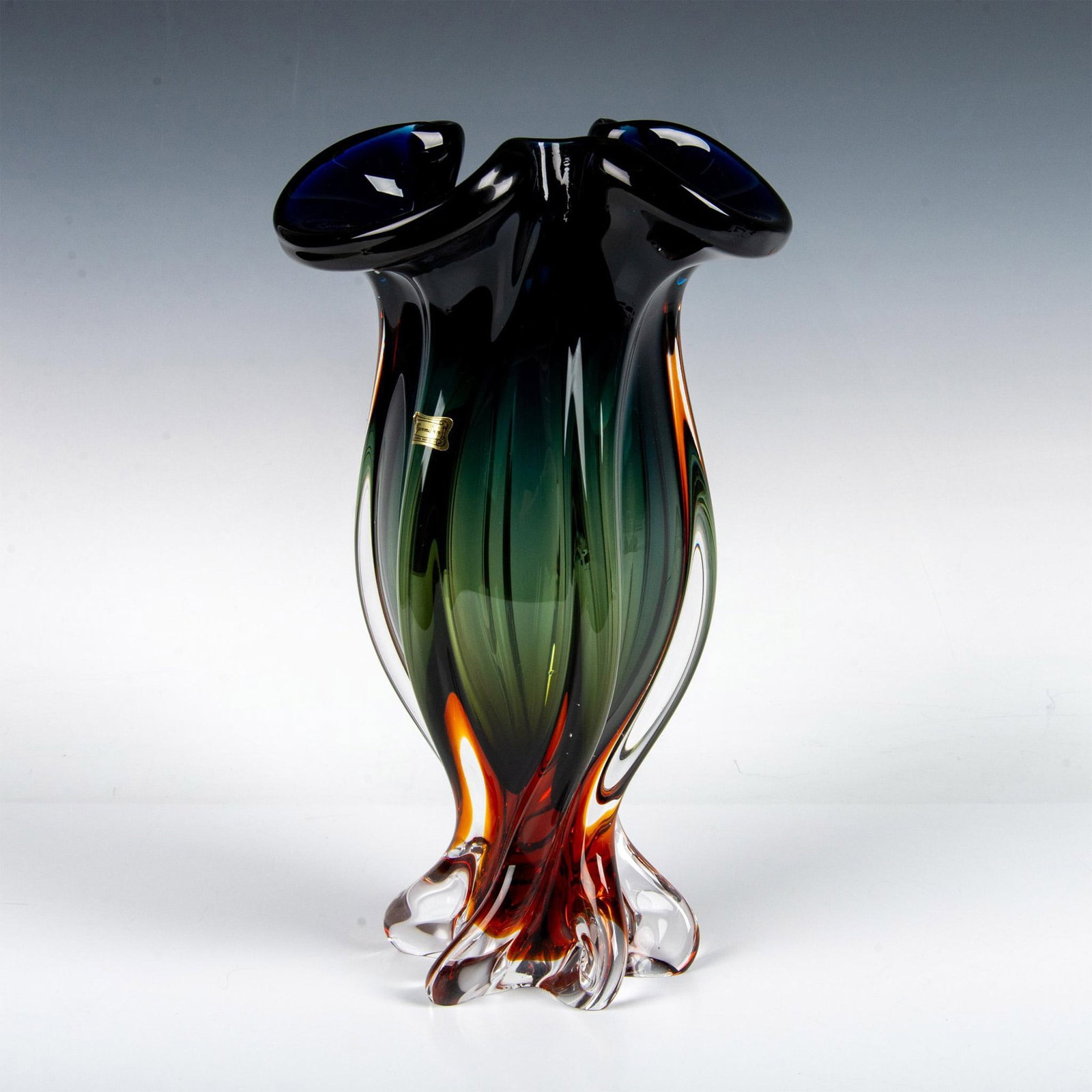 Egermann Czech Republic Art Glass Vase: Gorgeous, midcentury modern blended glass of green, blue and amber with furled top edge and twisted base. Egermann sticker and etched in base. Issued: 20th century Dimensions: 14"H x 8" dia. Manufactu