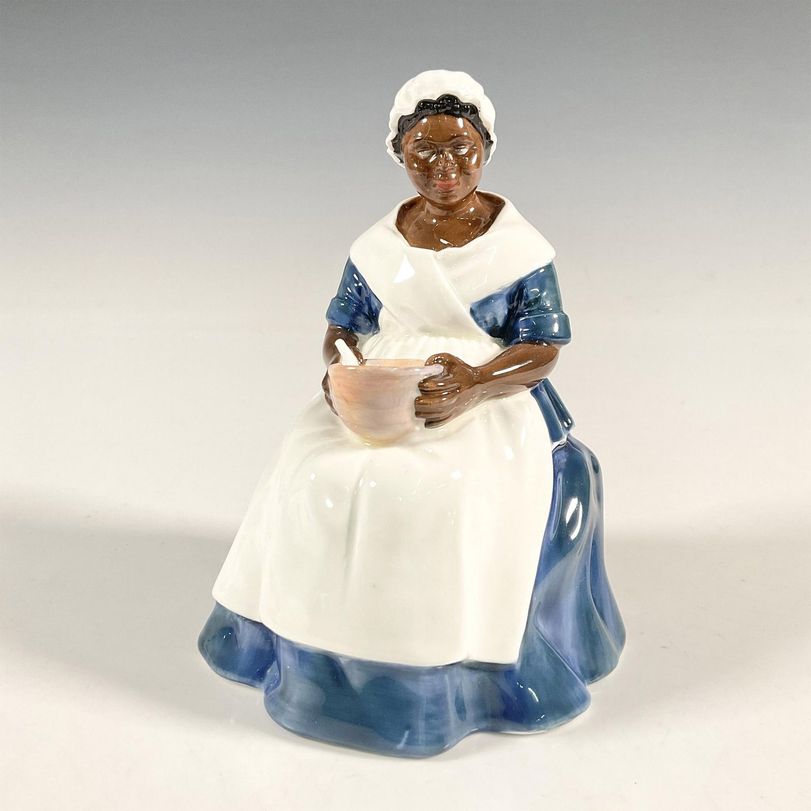 Royal Governor's Cook - HN2233 - Royal Doulton Figurine: Artist: Peggy Davies Issued: 1960 - 1983 Dimensions: 6"H Manufacturer: Royal Doulton Country of Origin: England