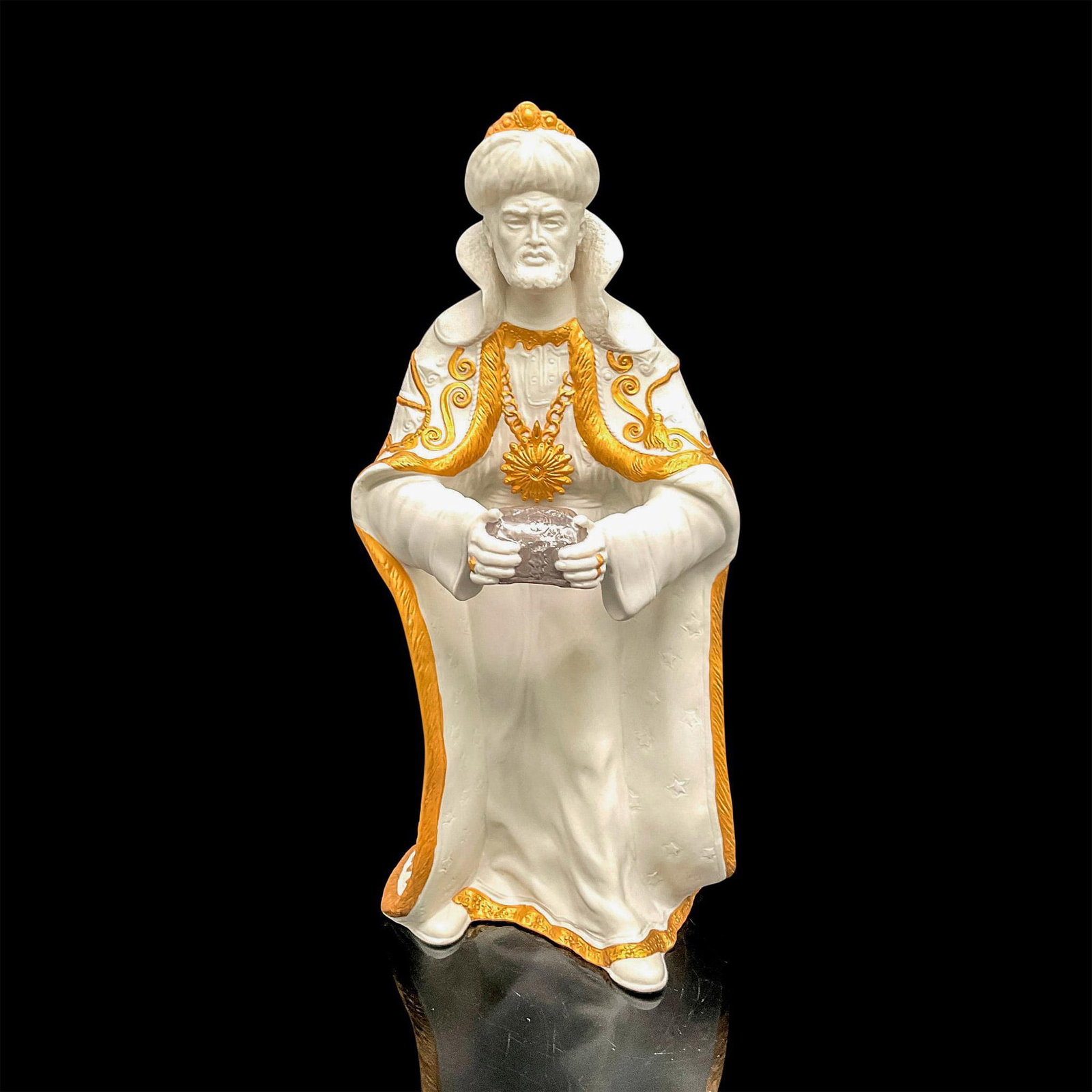 Boehm Christian Era Collection Figurine, King Balthazar: Part of the Spirit of Bethlehem collection, bisque figurine accented with golden color on crown, earrings, robe and rings, holding silver toned casket. Boehm backstamp. Issued: 20th century Dimensions