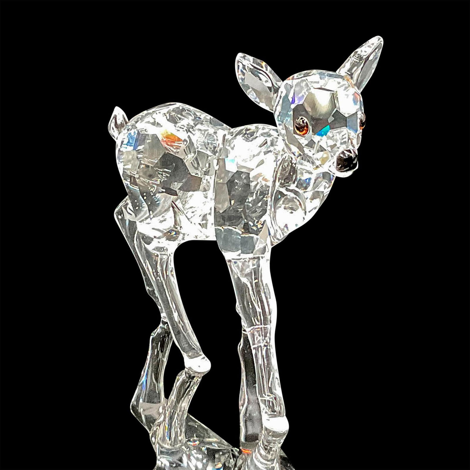 Swarovski Crystal Figurine, Fawn: Adorable clear crystal figure in walking stance with ears up with jet crystal eyes and nose. Swarovski backstamp. This item has its original box: 4"H x 5"dia. Certificate of Authenticity included. Iss