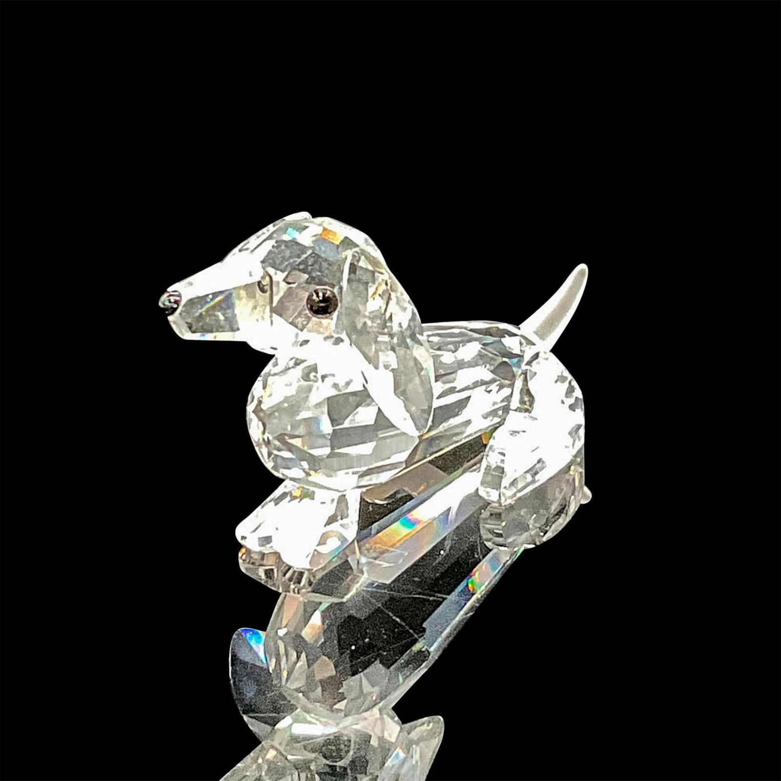 Swarovski Silver Crystal Figurine, Dachshund: Clear crystal figural is part of the Pets Corner series, identified by his frosted crystal tail, jet black eyes and nose. Swarovski backstamp. This item has its original box: 2.5"H x 3"dia. Artist: Ad