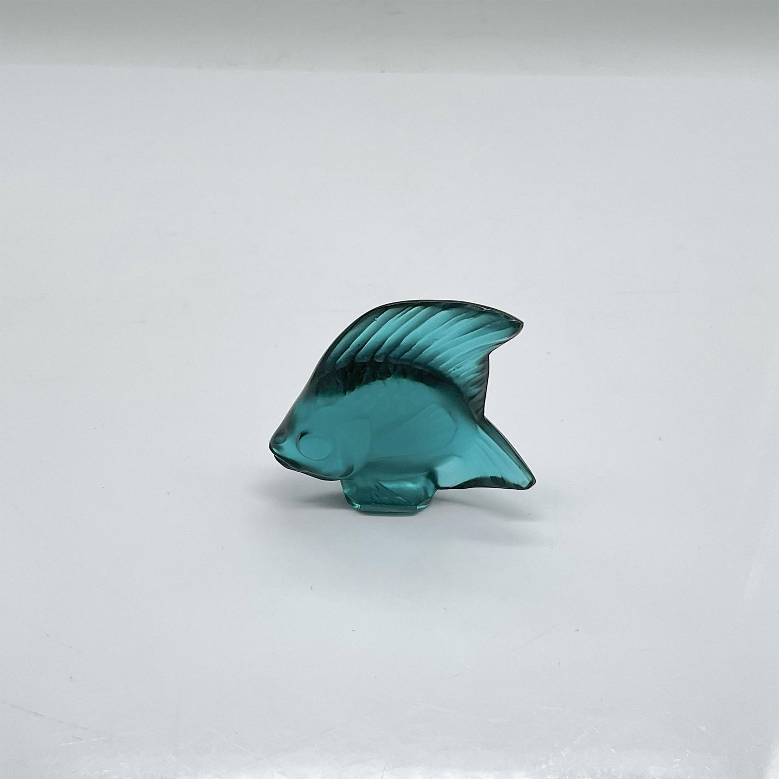 Lalique Crystal Blue Fish Figurine: Lalique crystal blue fish with frosted highlights. Lalique impressed mark. Issued: 20th century Dimensions: 2.25"L x 1"W x 2"H Manufacturer: Lalique Country of Origin: France