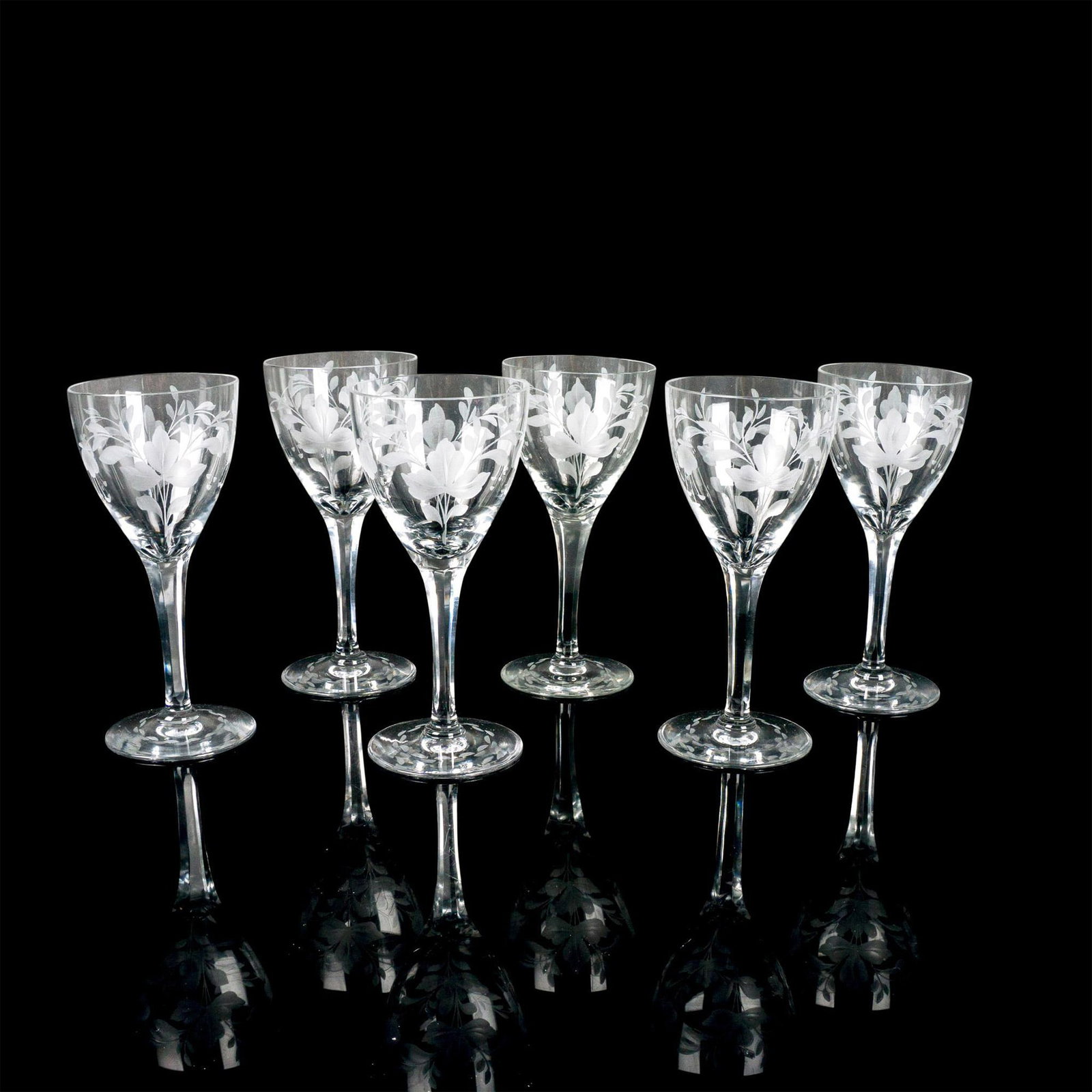 6pc Decorative Glass Wine Glassware: A set of stemmed wine glasses with etched floral designs. Issued: 20th c. Dimensions: 7"H x 3.25" dia.