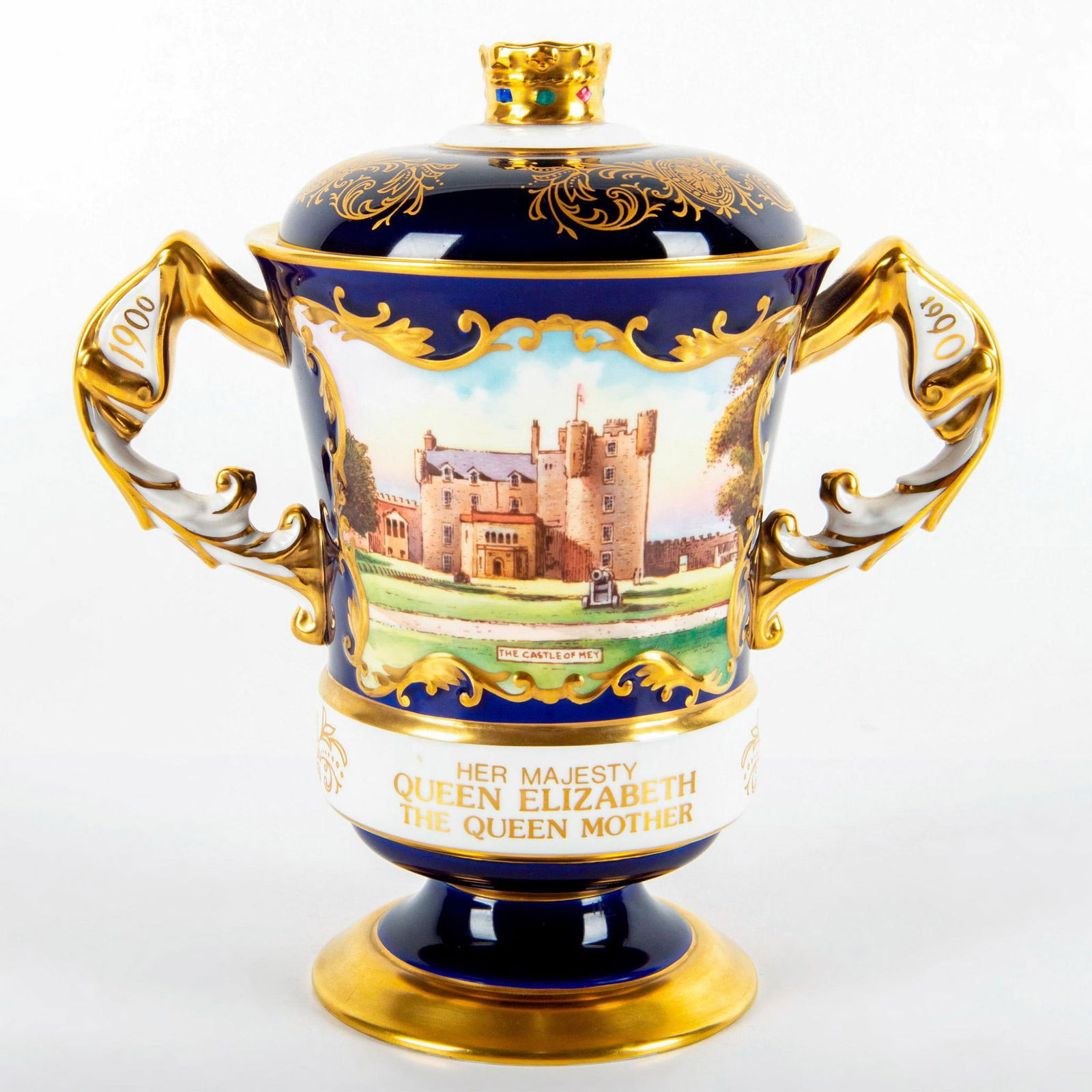 Aynsley China Lidded Vase, Queen Elizabeth, Castle of Mey: Peter Jones Collection; ltd edition 44 of 90. To commemorate the 90th year of Queen Elizabeth, the Queen Mother. Double handled; footed base; cover. Hand painted panel of the Castle of Mey. Blue and w