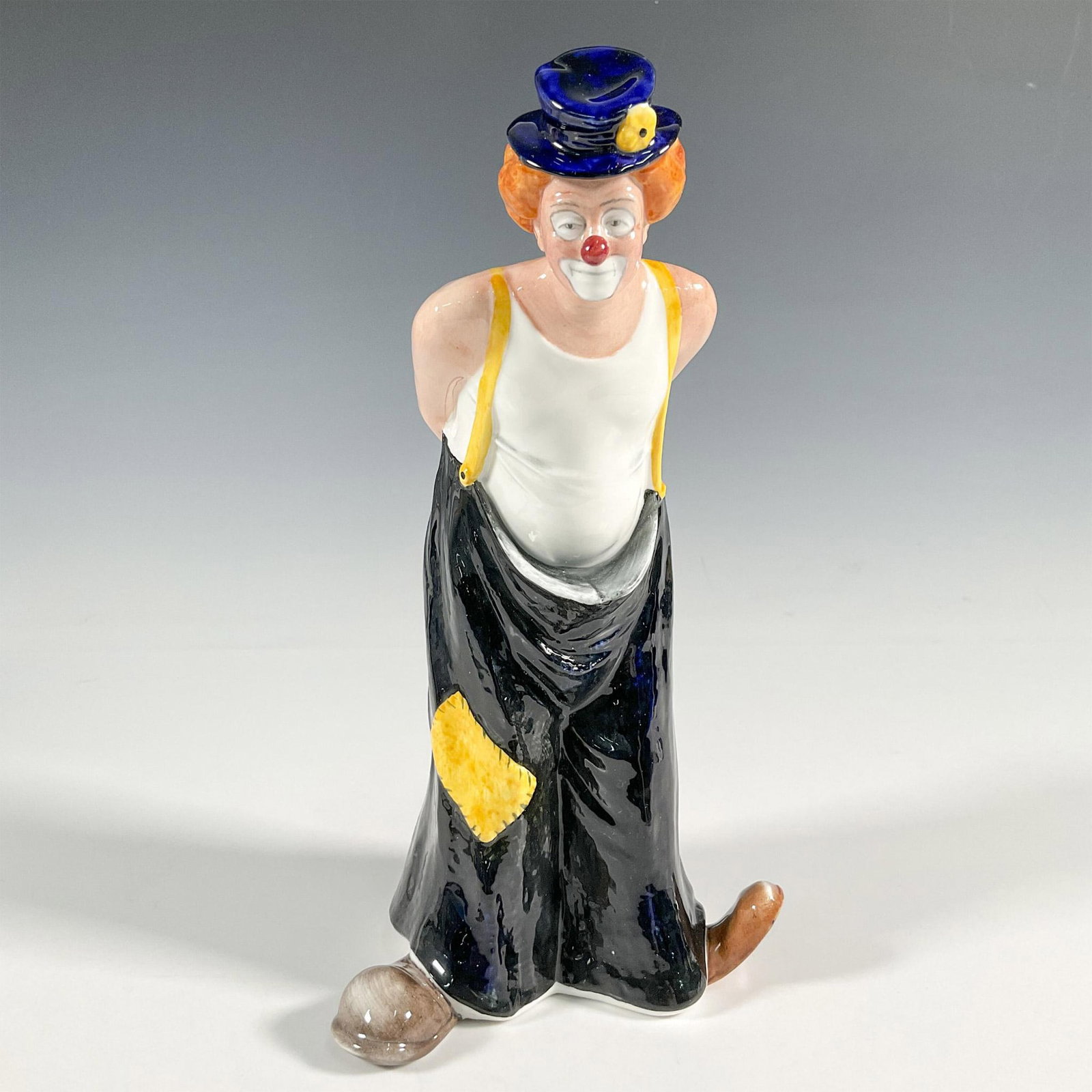 Tip Toe - HN3293 - Royal Doulton Figurine: Part of the Clown series. Clown is standing wearing a white shirt with black and yellow overalls. Royal Doulton backstamp. Artist: Mary Nicoll Issued: 1990-1994 Dimensions: 4.75"L x 4.25"W x 9"H Manuf