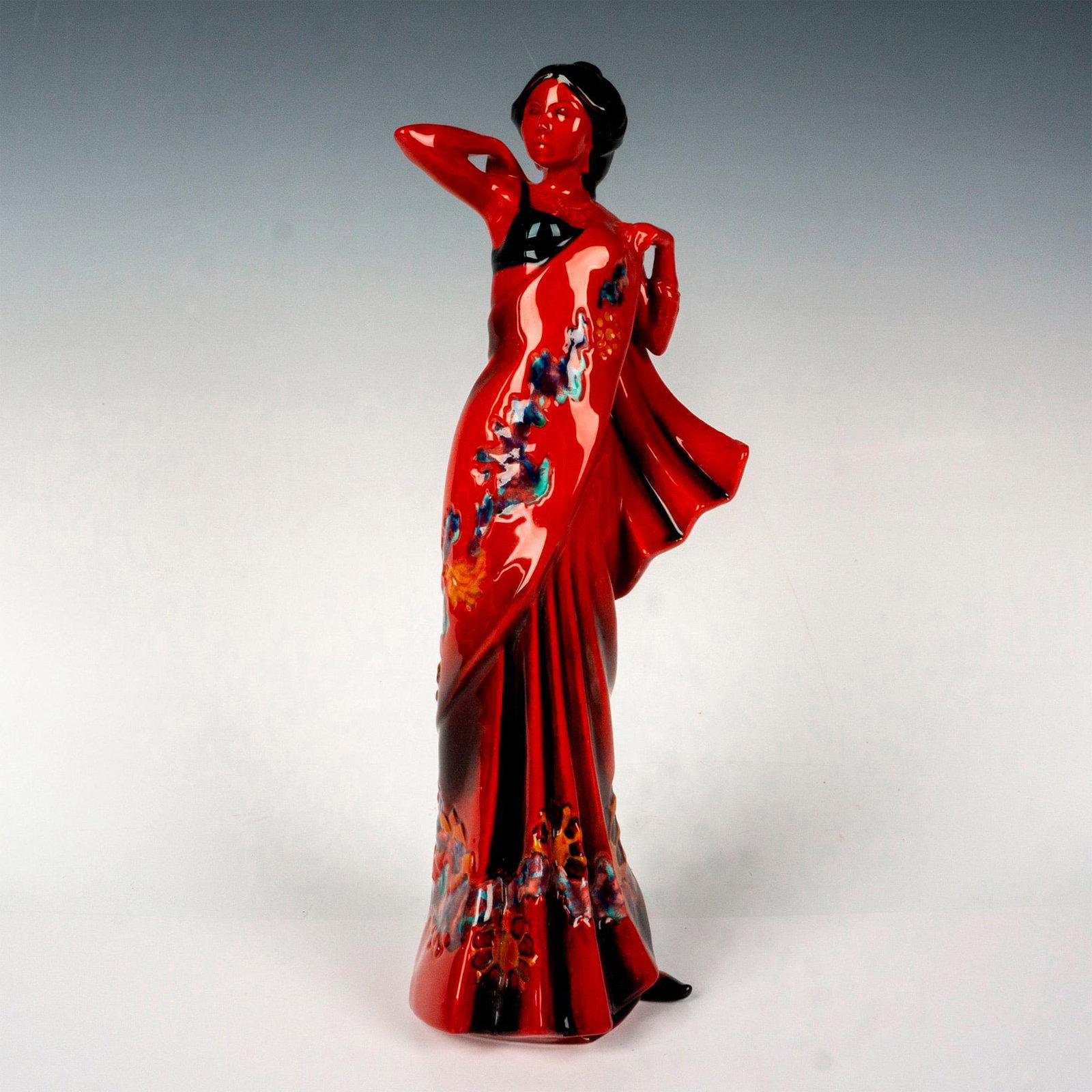 Royal Doulton Flambe Figurine, Eastern Grace HN3683: Limited edition figurine study of an Eastern beauty wearing her floral native dress. Royal Doulton backstamp. Artist: Pauline Parsons Issued: 1995 Dimensions: 4.5"L x 4"W x 12.5"H Edition Number: 40 o