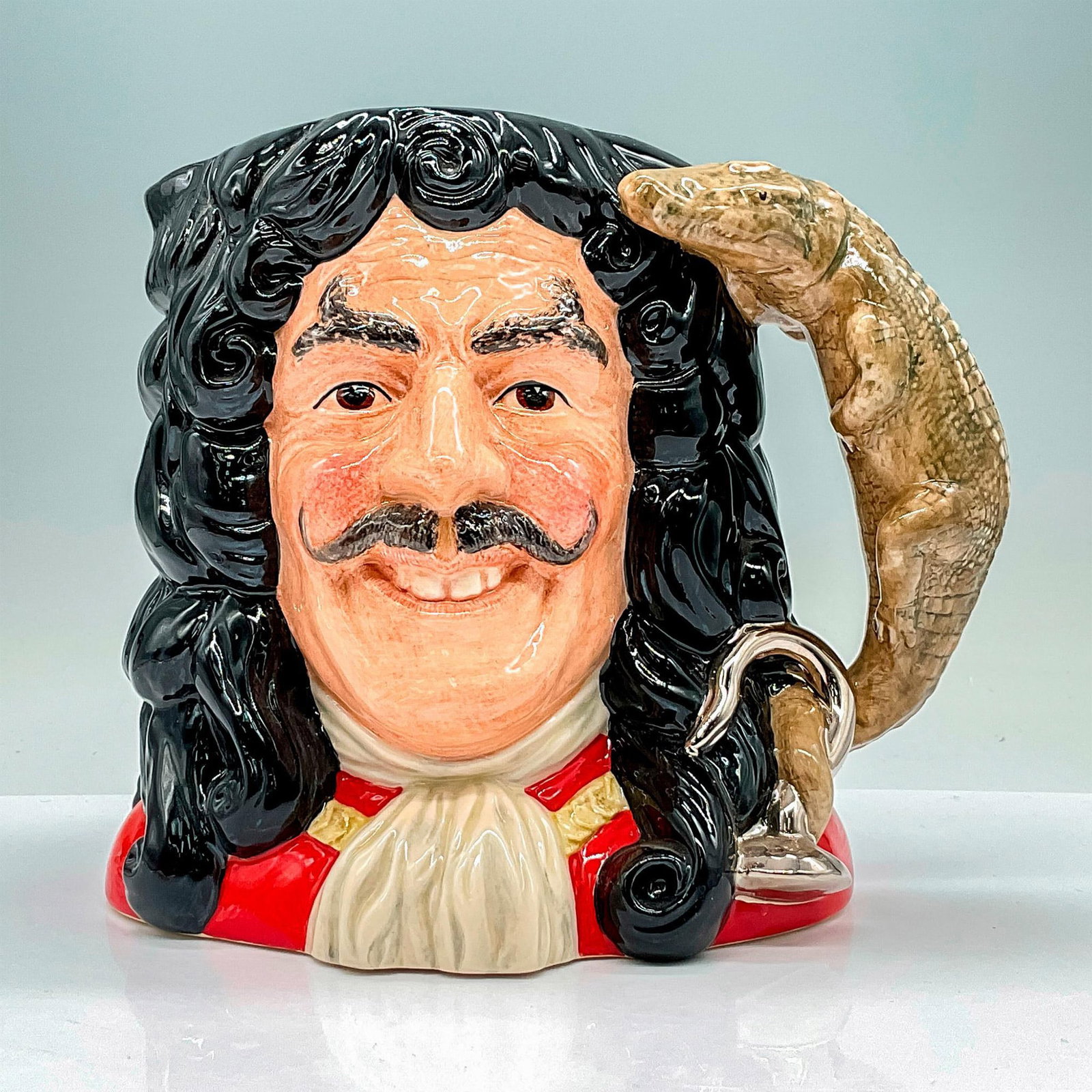 Capt Hook New D6947 - Large - Royal Doulton Character Jug: Style Two. Black, scarlet, and grey coloration. Royal Doulton backstamp. Artist: Martyn C. R. Alcock Issued: 1994 - 1994 Dimensions: 7.5"H Manufacturer: Royal Doulton Country of Origin: Englan