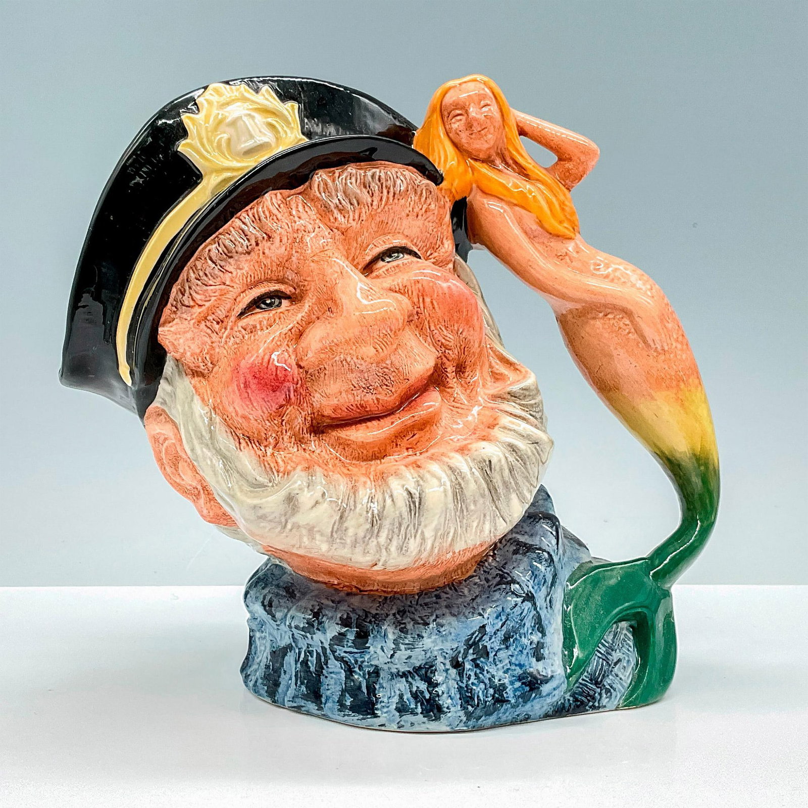Old Salt D6782 - Large - Royal Doulton Character Jug: Features the depiction of an old, bearded ship's captain. New colourway with light blue over dark blue fisherman's jersey and mermaid has yellow to green tail. Royal Doulton backstamp. Artist: Gary Sh