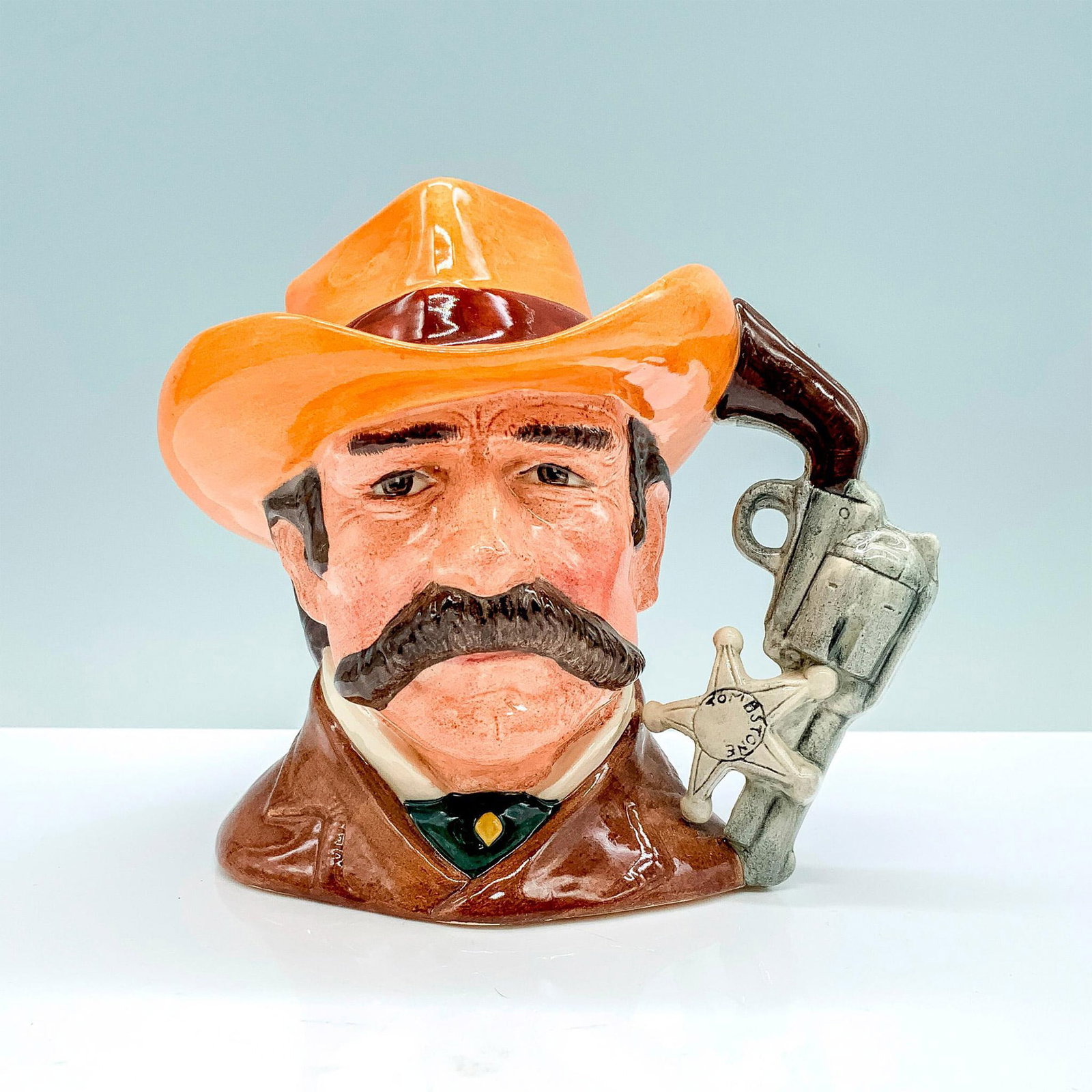 Wyatt Earp D6711 - Odd Size - Royal Doulton Character Jug: Brown coat; light brown hat with red band. Royal Doulton backstamp. Artist: Stanley J. Taylor Issued: 1985 - 1989 Dimensions: 5.5"H Manufacturer: Royal Doulton Country of Origin: England
