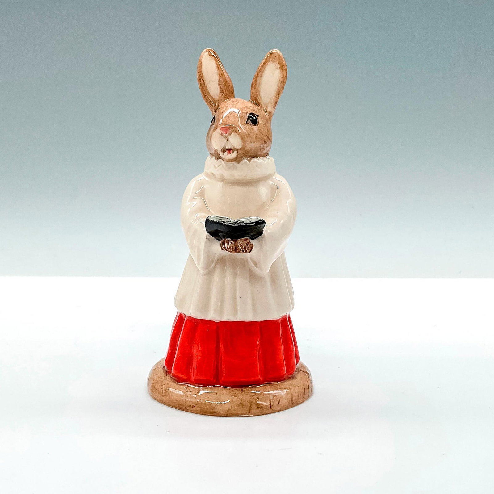 Choir Singer DB223 - Royal Doulton Bunnykins: Box included. Box measures approximately 2.5"L x 3.5"W x 5.75"H. Artist: M. Alcock Issued: 2001 - 2001 Dimensions: 4"H Manufacturer: Royal Doulton Country of Origin: England