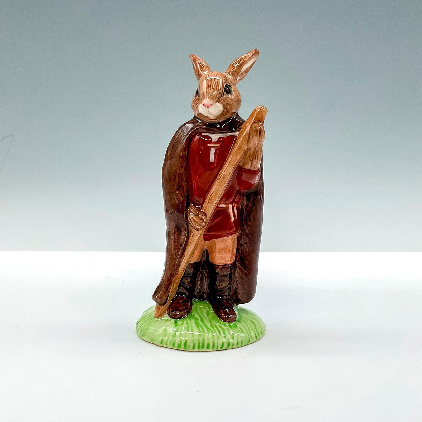 Little John DB243 - Royal Doulton Bunnykins: Box included. Box measures approximately 2.5"L x 3.5"W x 5.75"H. Artist: M. Alcock Issued: 2001 - 2003 Dimensions: 5"H Manufacturer: Royal Doulton Country of Origin: England