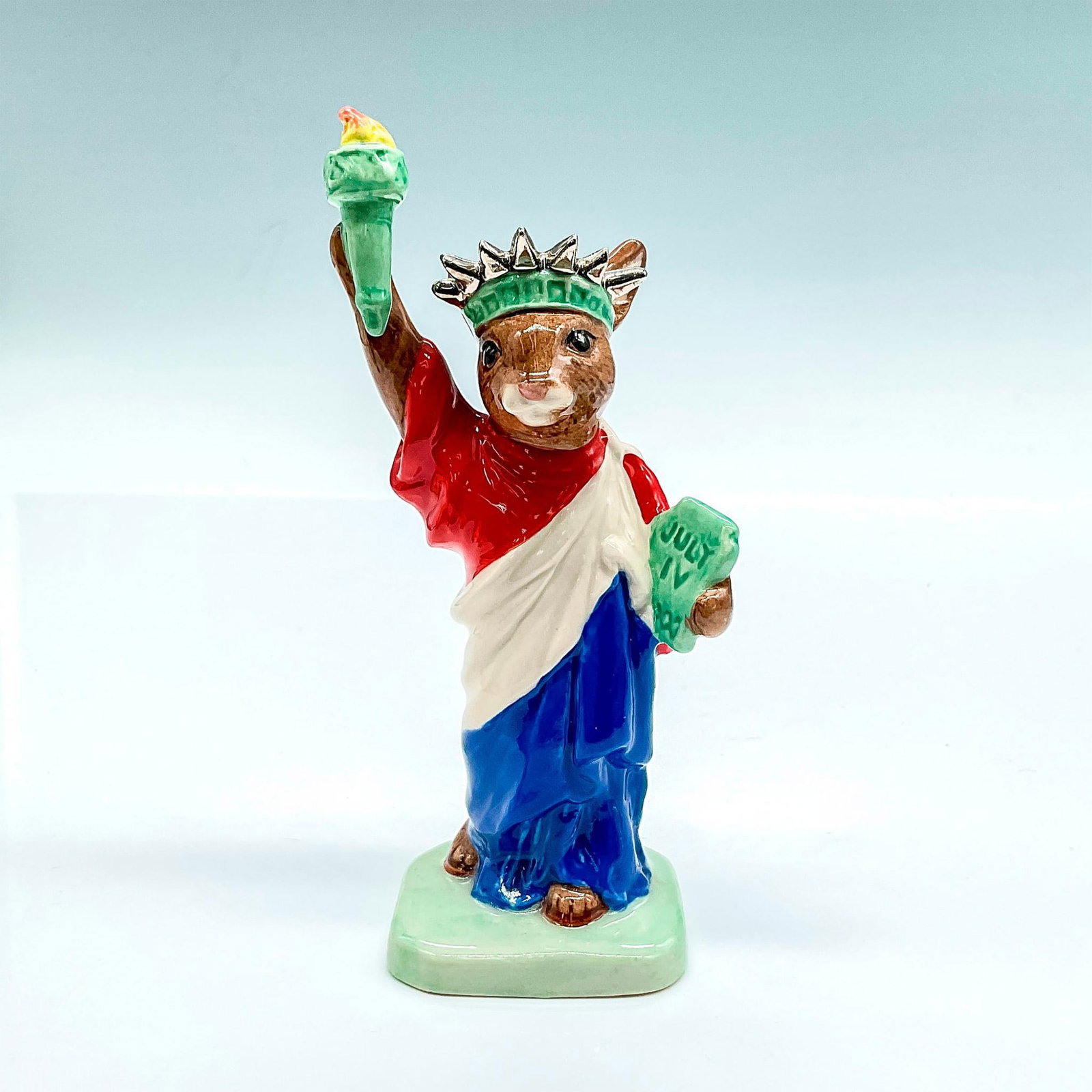 Statue of Liberty DB198 - Royal Doulton Bunnykins: Box included. Box measures approximately 2.5"L x 3.5"W x 5.75"H. Artist: C. Dadd Issued: 1999; S.E. 3,000 Dimensions: 5"H Edition Number: 805 Edition Size: 3000 Manufacturer: Royal Doulton