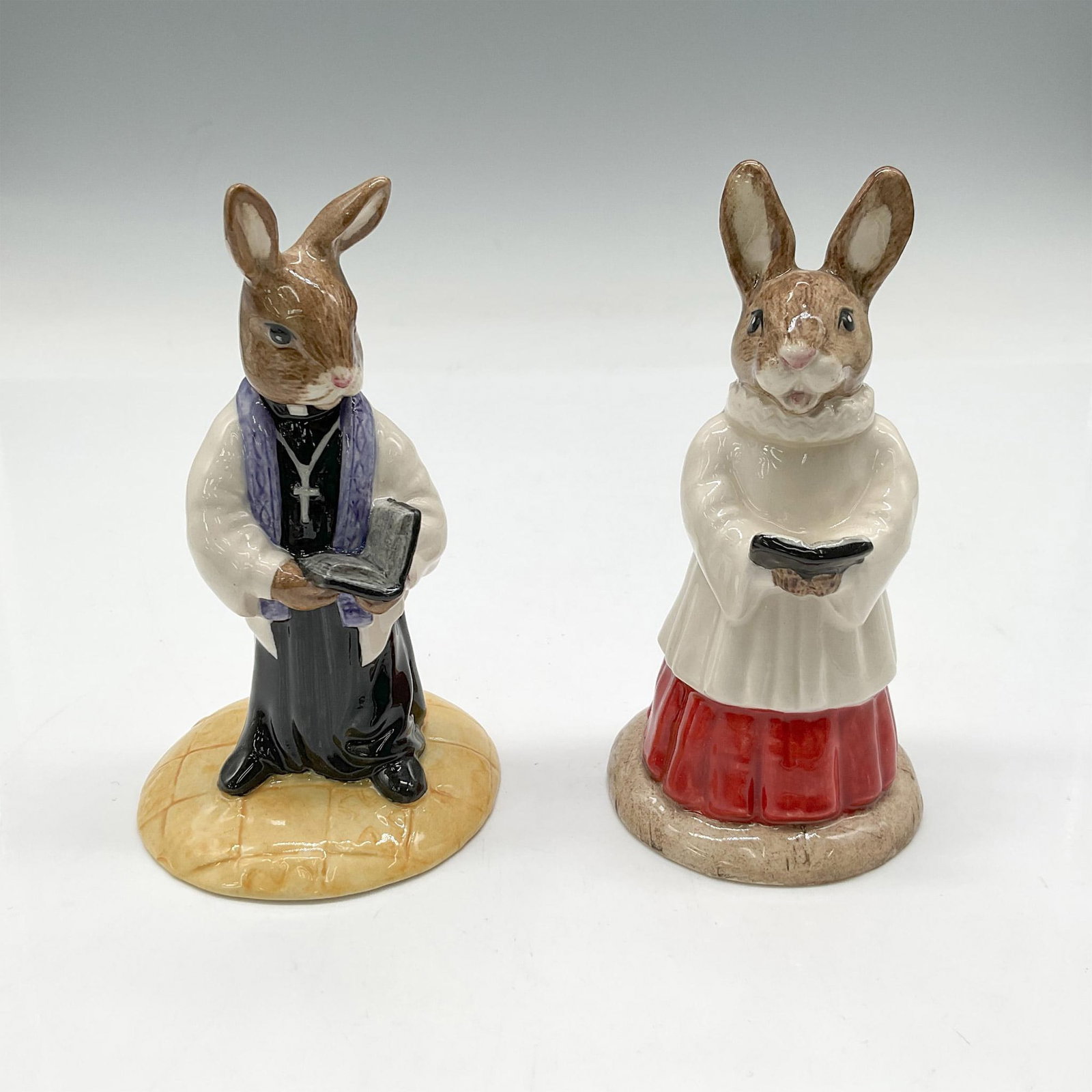 2pc Royal Doulton Bunnykins, Church Group DB223 + DB254: Hand painted figures includes DB223 Choir Singer and DB254 Vicar. Both created exclusively for International Collectors Club. Royal Doulton backstamp. Artist: Martyn Alcock, Shane Ridge Issued: 2001 D
