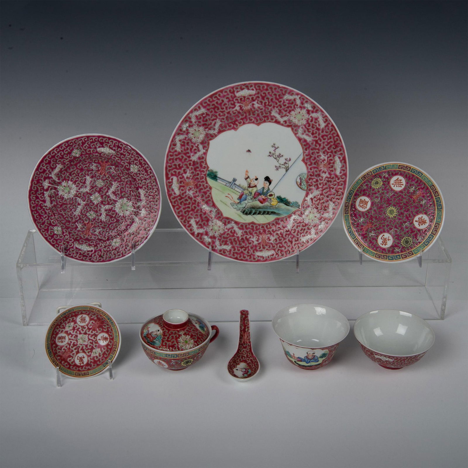 8pc Chinese Porcelain Serving Set: Serveware in a magenta pink background with floral decoration and provincial scenes. Chinese character backstamps. Largest plate 1.25"H x 10" dia. Salad plate 1"H x 7" dia. Appetizer plate, mini bowl,