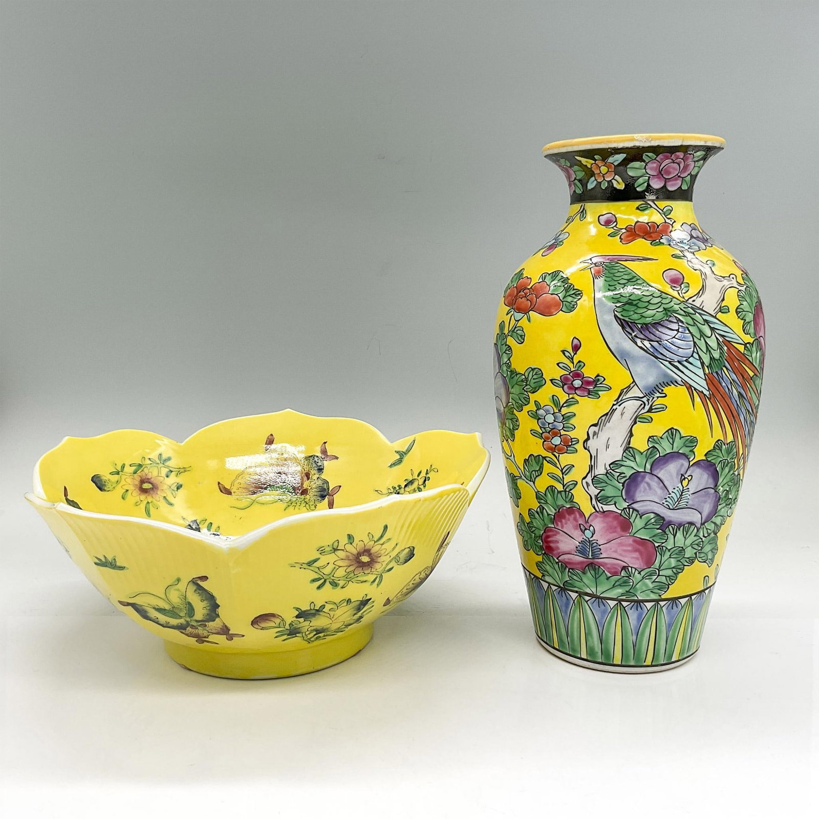 2pc Japanese Bowl and Vase, Butterflies and Flowers: Porcelain bowl, yellow background with floral and butterfly design; 3.75"H x 8.75" dia. Earthenware vase, yellow background with pheasant and floral design; 9.5"H x 4.25" dia. Country of Origin: Japan