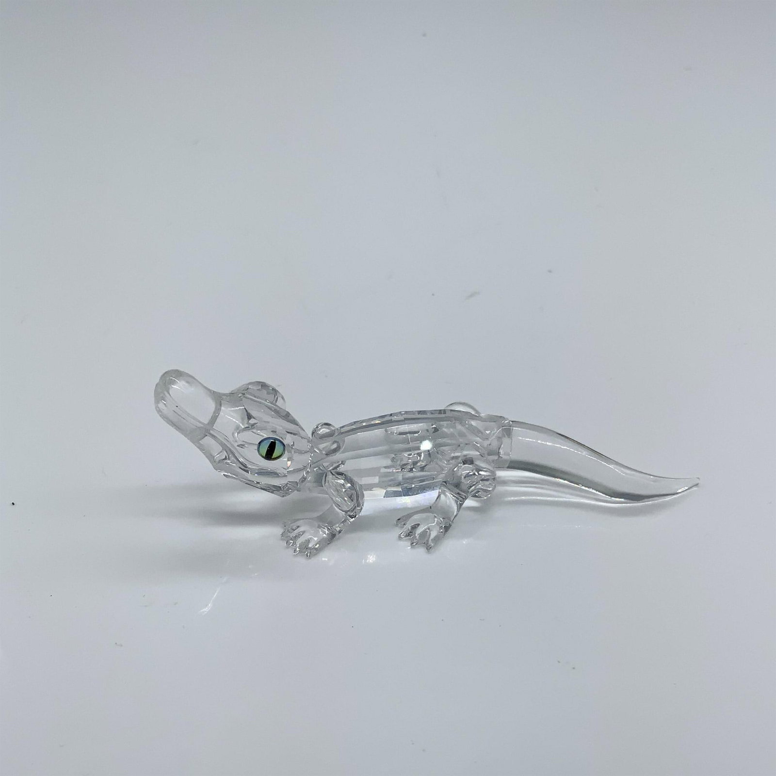 Swarovski Silver Crystal Figurine, Alligator 221629: This retired crystal alligator was made in clear facetted and molded crystal. It comes with its original box which measures 3.25"dia. x 4.75"H. Artist: Michael Stamey Issued: 1998-2005 Dimensions: 3.2
