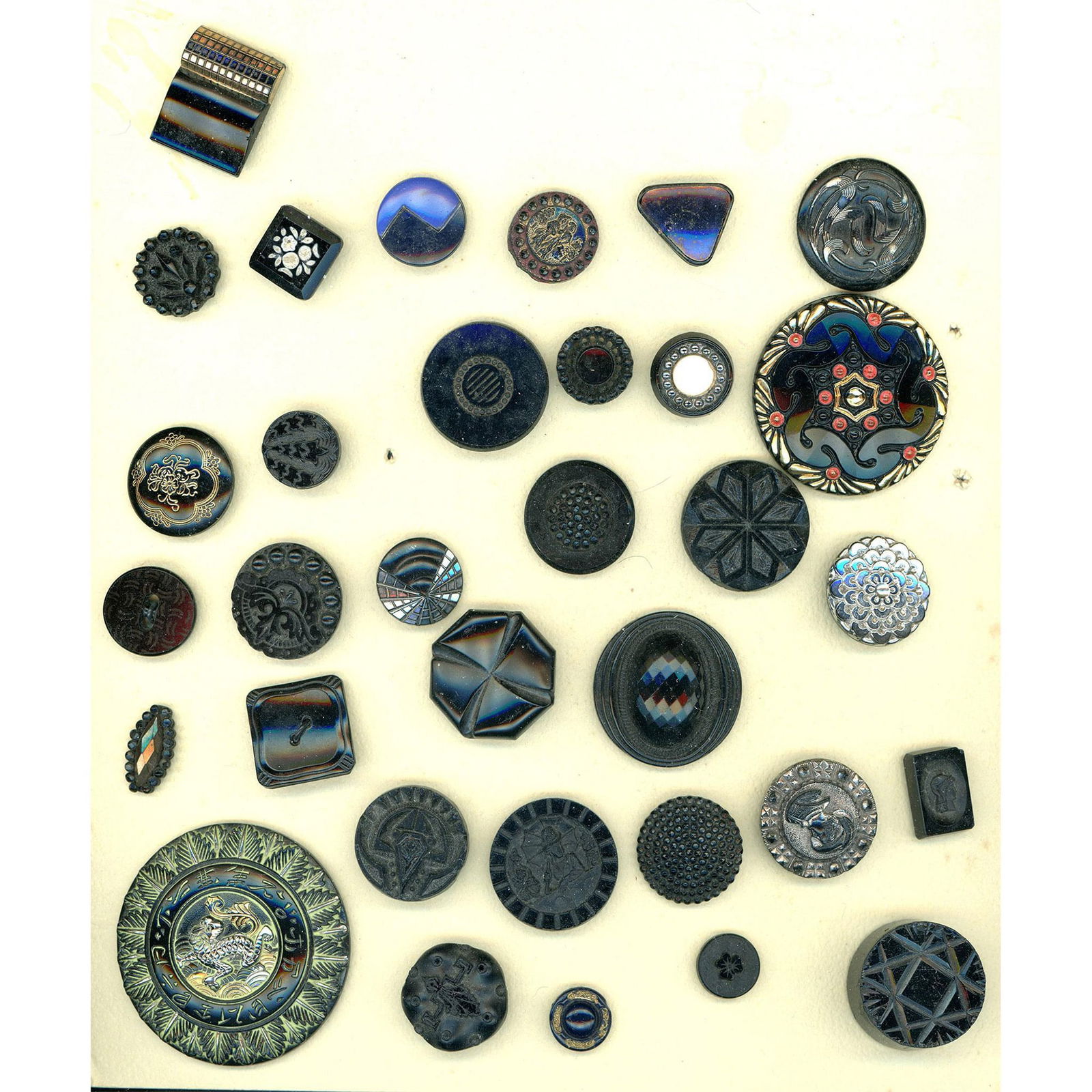 A card of division one and three black glass buttons (1 of 3)