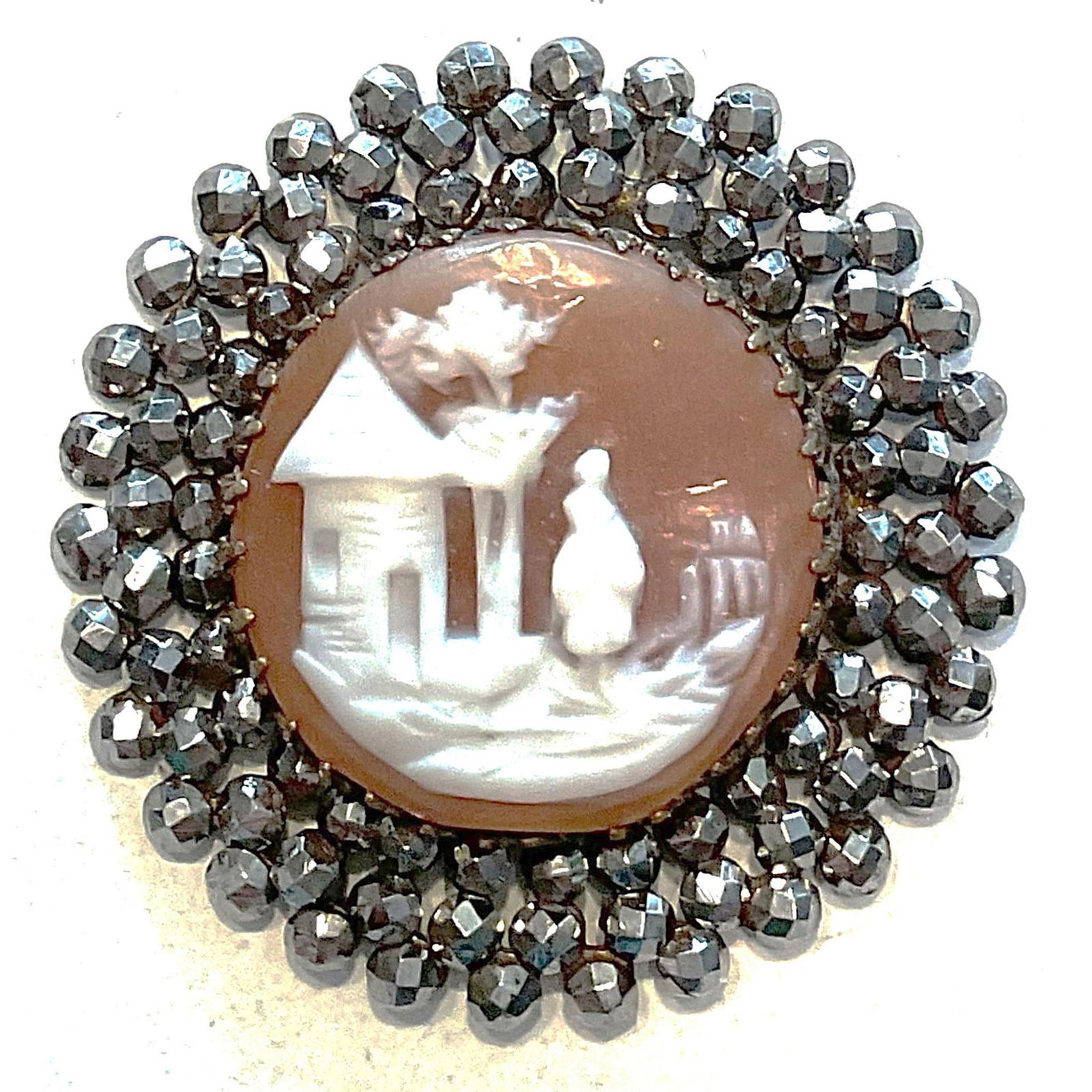 A division one carved shell pictorial in metal button: 1 Large medium 19th century carved helmet shell button. From the collection of the late Shirley Case who wrote the NBS pearl classification book comes this beautifully pristine cut steel bordered helm