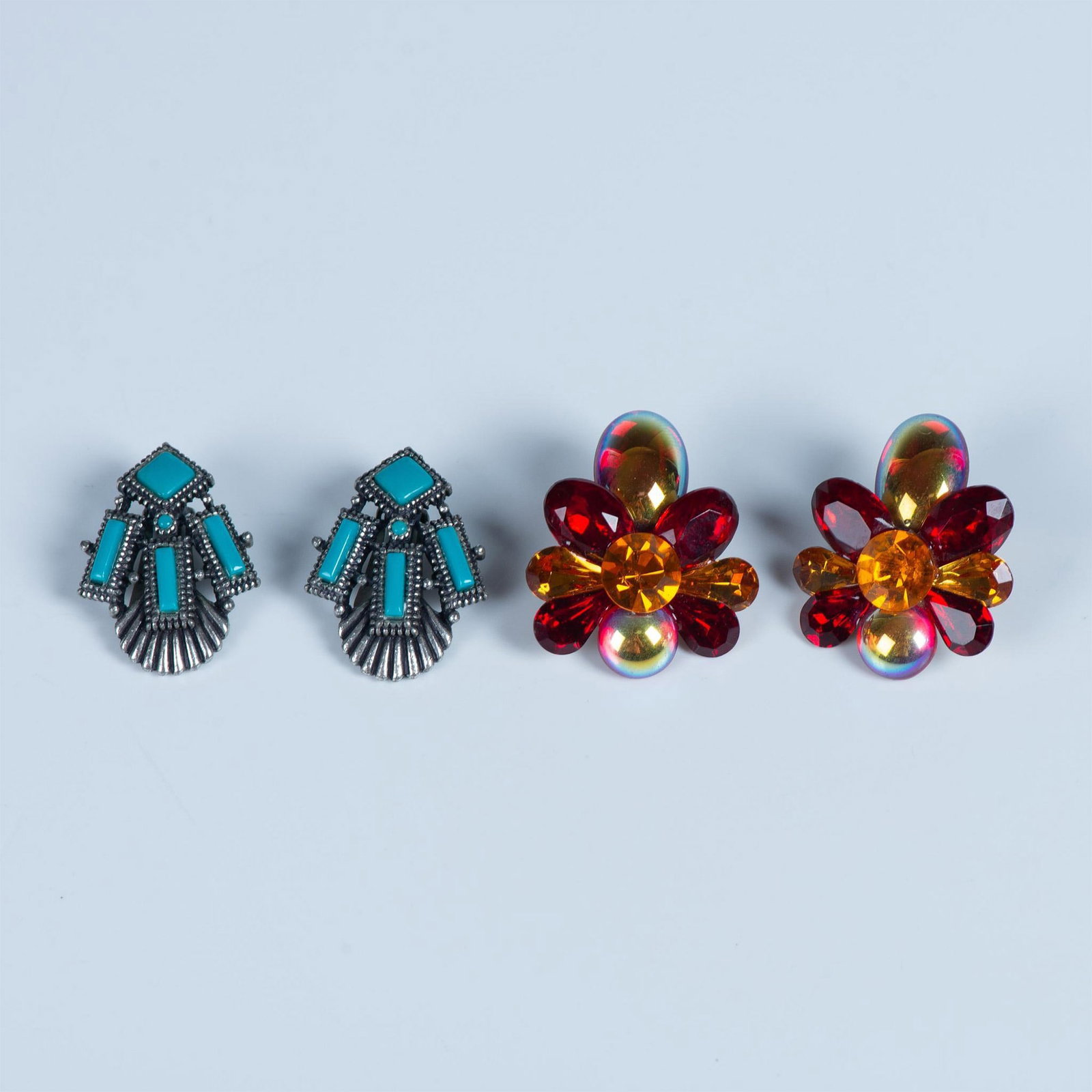 2pr Clip Back Earrings: Beautiful flowers of faceted and cabochon stones in orange, red and iridescent gold. Silver tone and turquoise color stones in a Native American style setting. Backstamp NYT. Native American: 1.25"L x