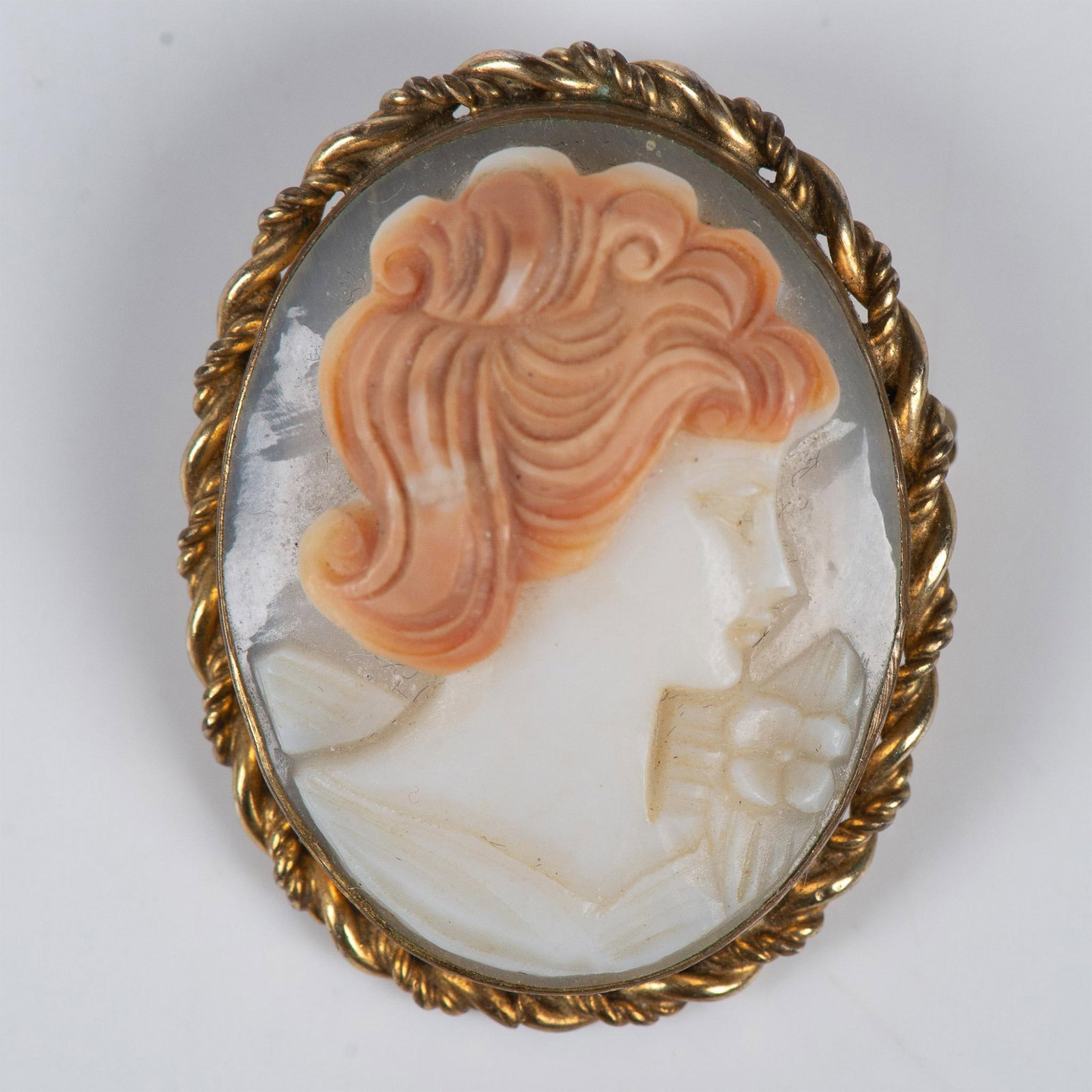 Marbro Cameo Pendant-Brooch: This lovely lady is hand carved from shell with a tousle of auburn hair. The cameo is in a gold filled setting with a rope edge. Can be worn as a brooch or a pendant. Backstamp 12 KGF Marbro . Issued: