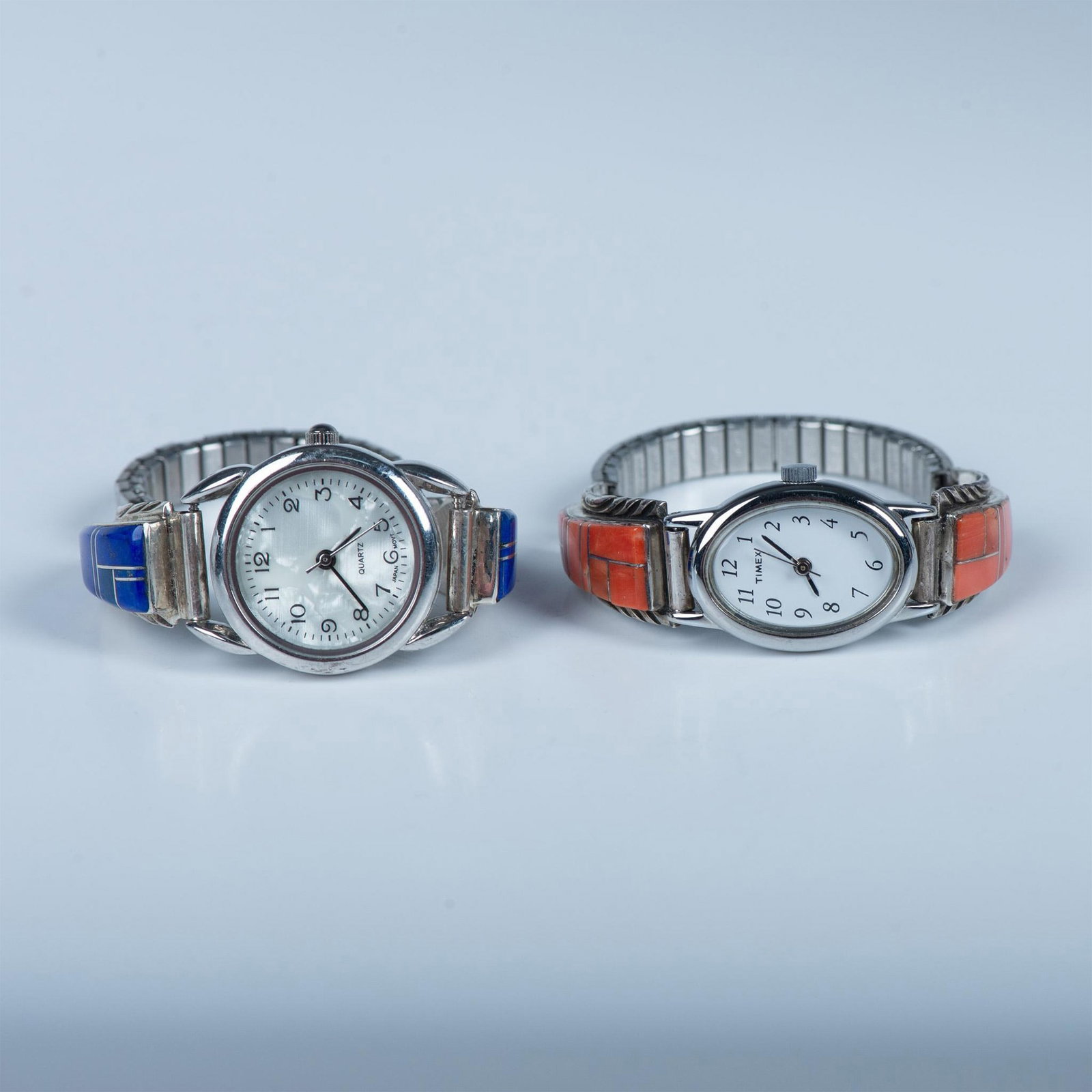 2pc Sterling Silver and Stone Watches: Very similar in design both watches are sterling silver with stone inlay. One is blue lapis with a round quartz movement watch with a mother of pearl face set in a silver tone and stainless steel case