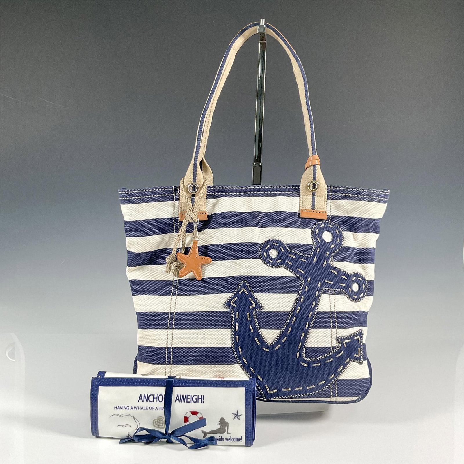 2pc Brighton Canvas Handbag and Jewelry Roll Case, Nautical: Navy and off white striped canvas handbag with interior pockets, zippered closure, leather straps and accents; 15"L x 3"W x 12"H. Length of shoulder straps is 8.5"L. Brighton leather patch stitched on