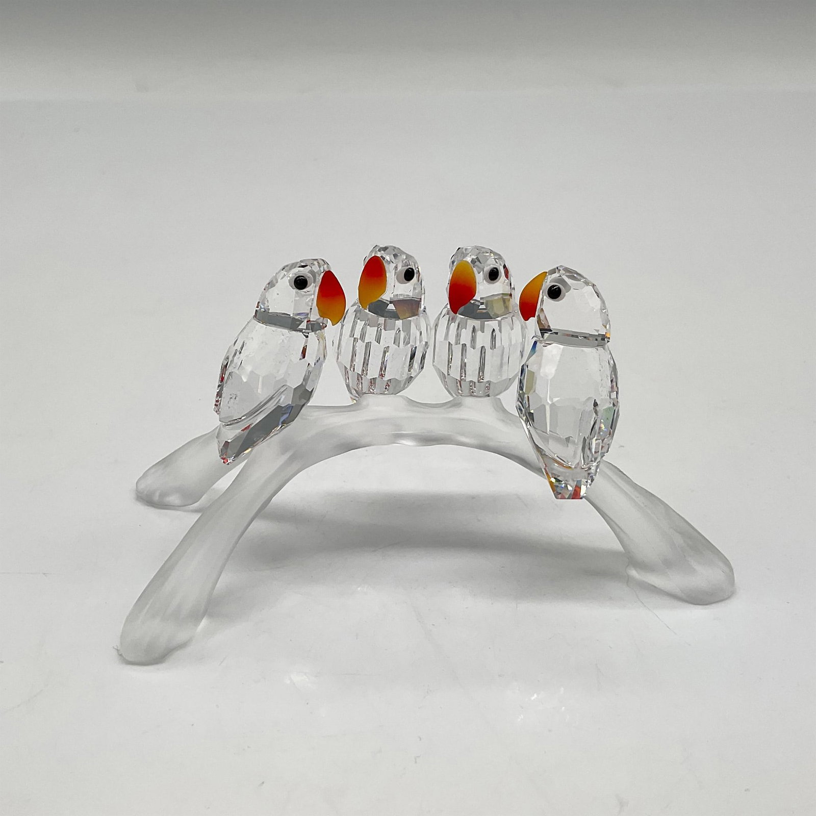 Swarovski Crystal Figurine, Baby Lovebirds: Part of the Feathered Beauties theme group, these sweet birds have clear crystal bodies with fire opal beaks and jet-black crystal eyes sitting on a frosted crystal branch. Swarovski backstamp. 7621 0