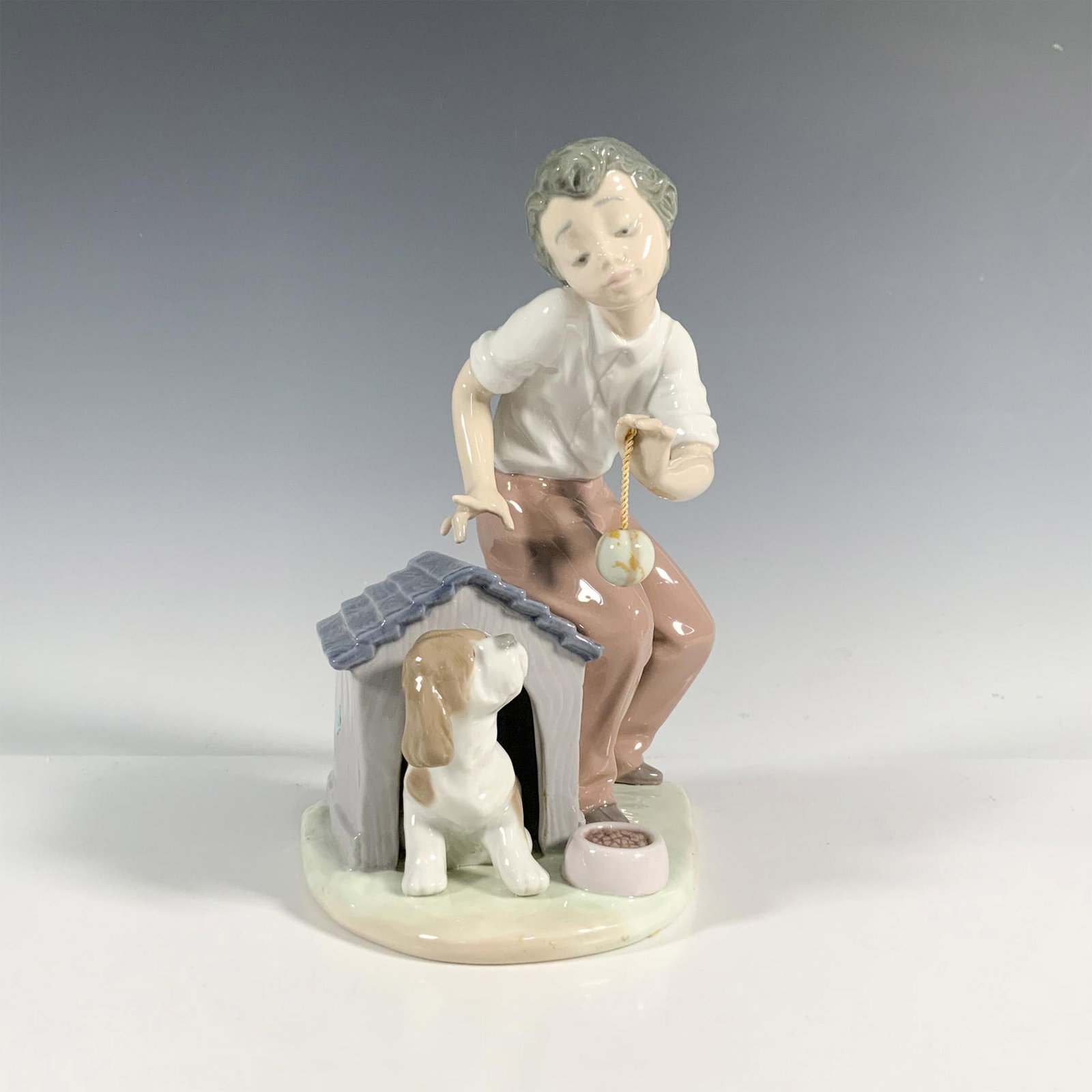 Come Out And Play 1005797 - Lladro Porcelain Figurine: Glossy finish; Lladro backstamp. Includes original box. Dimensions of the box: 9.75"L x 8.75"W x 6.5"H. Artist: Joan Coderch Issued: 1991 - 1994 Dimensions: 7.75"H Manufacturer: Lladro Country of
