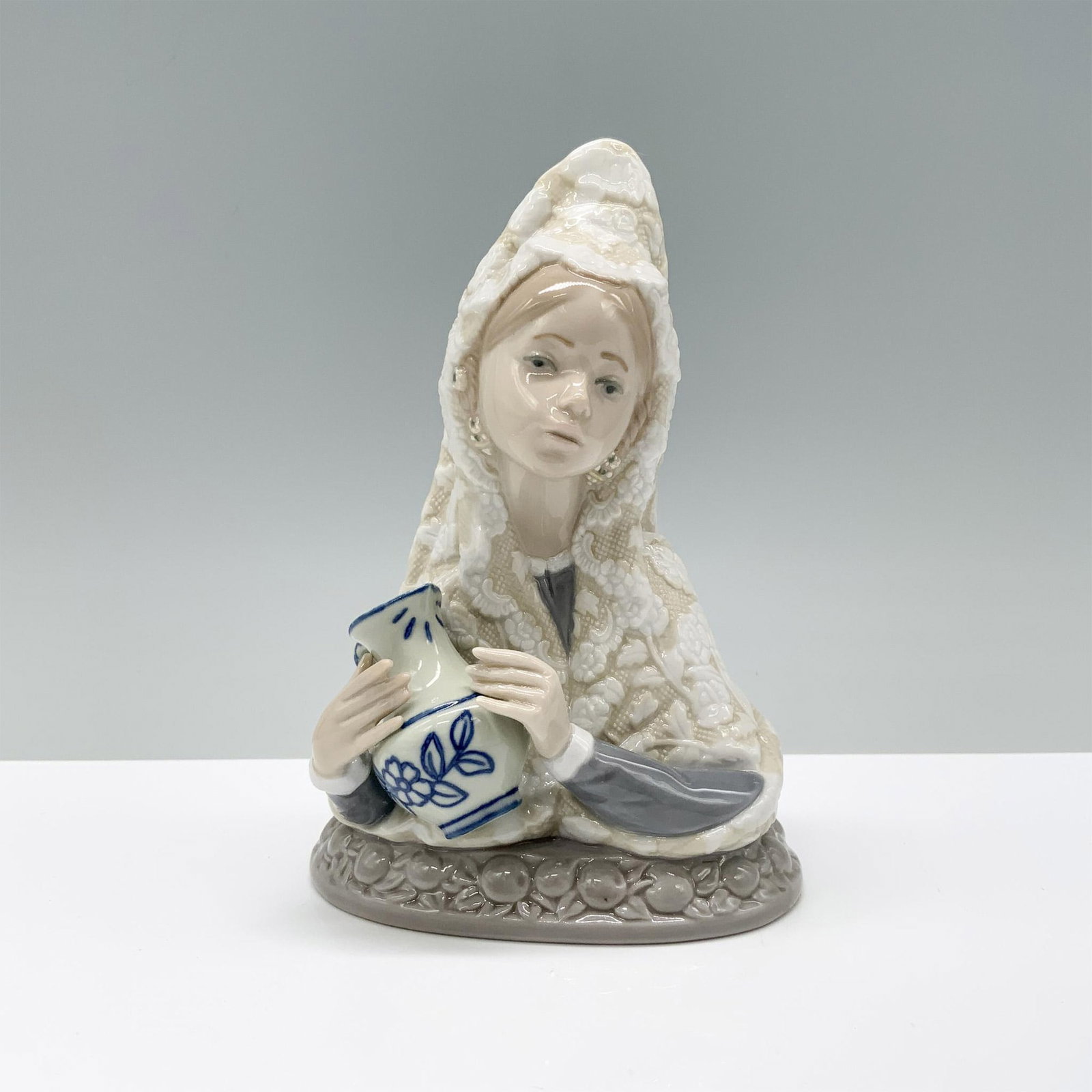 Valencian Beauty 1005670 - Lladro Porcelain Bust: Glossy finish; Lladro backstamp. Includes original box. Dimensions of the box: 7.75"L x 5"W x 5"H. Artist: Juan Huerta Issued: 1990 - 1993 Dimensions: 6"H Manufacturer: Lladro Country of Origin:</