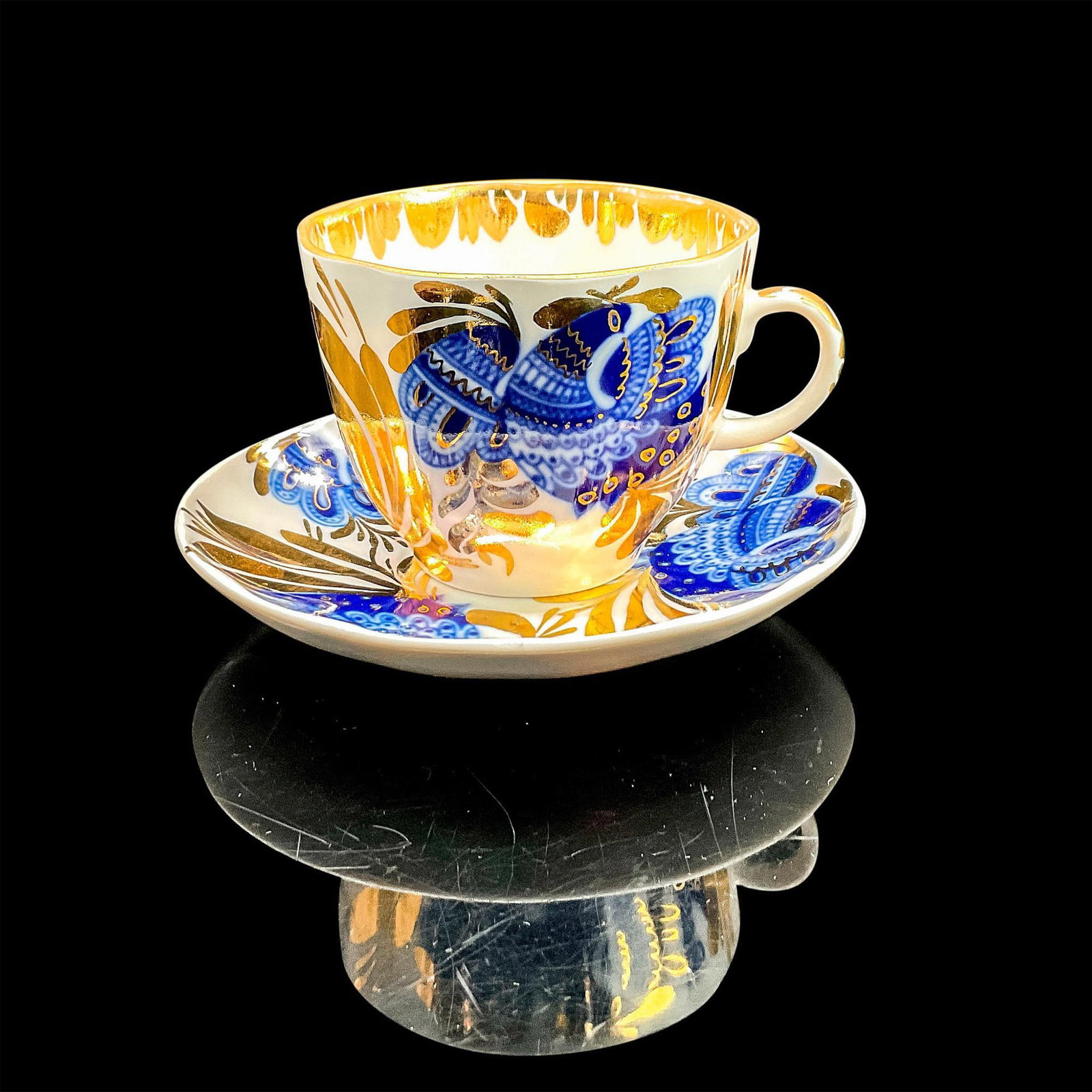 2pc Lomonosov Bone China Cup and Saucer, Golden Garden: Tea cup and saucer with vibrant blue and gold bird with leaves design. Lomonosov backstamp. Cup 3.5"L x 3"W x 2.25"H. Saucer 0.75"H x 4.5" diameter. Manufacturer: Lomonosov