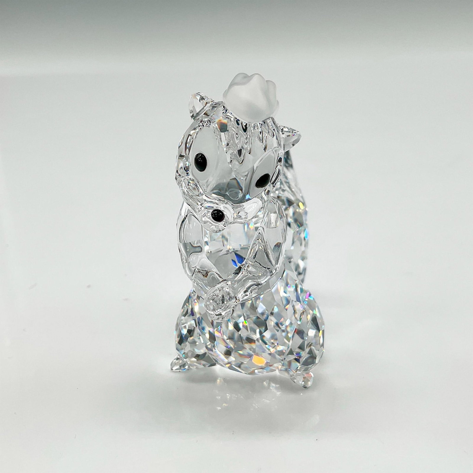 Swarovski Crystal Figurine, Disney's Flower from Bambi: Adorable figure from Disney's Bambi movie has clear faceted crystal body and tail with satin crystal top mane, jet crystal eyes and nose. Swarovski backstamp. 0943601. This item has its original box: 