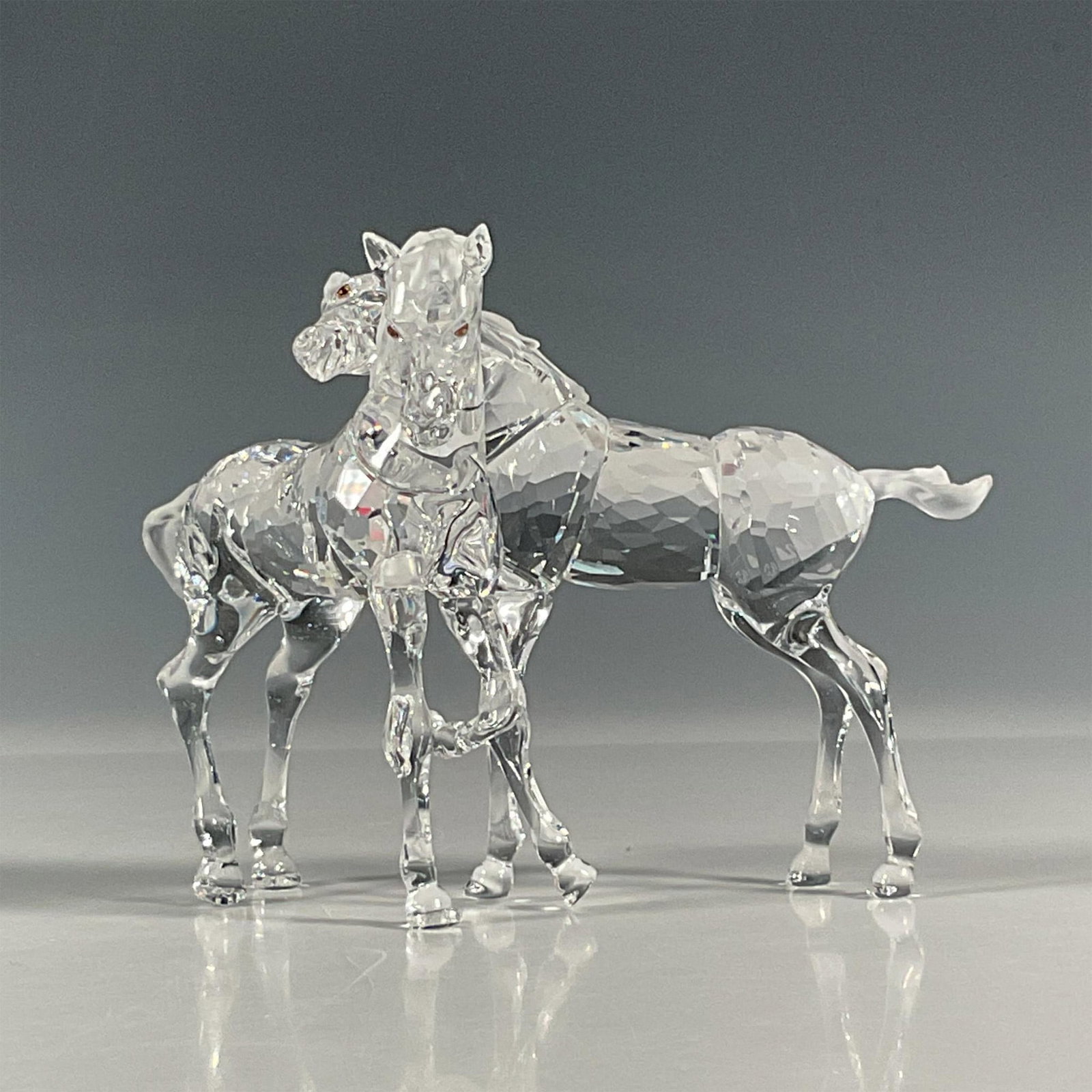 Swarovski Crystal Figurine, Foals: Retired crystal foals that were part of the Peaceful Countryside collection. Two lead crystal baby horses prance about playfully. Swarovski etched backstamp. This item has its original box. Box measur