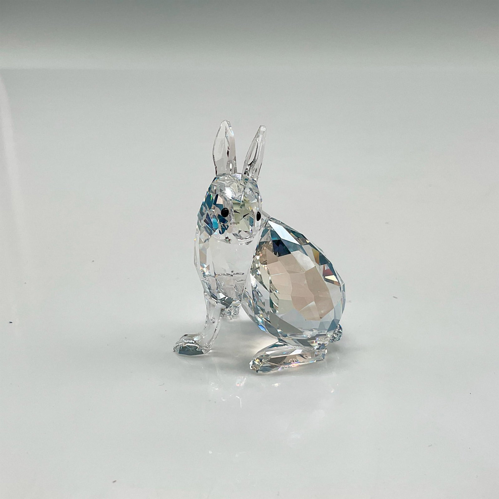 Swarovski Crystal Figurine, Artic Hare, Signed: This gorgeous figural was the 2011 SCS Event piece and was only available at that time. Made of Crystal Moonlight color crystal with jet crystal eyes. Signed. Swarovski backstamp. 9100 000 261. This i