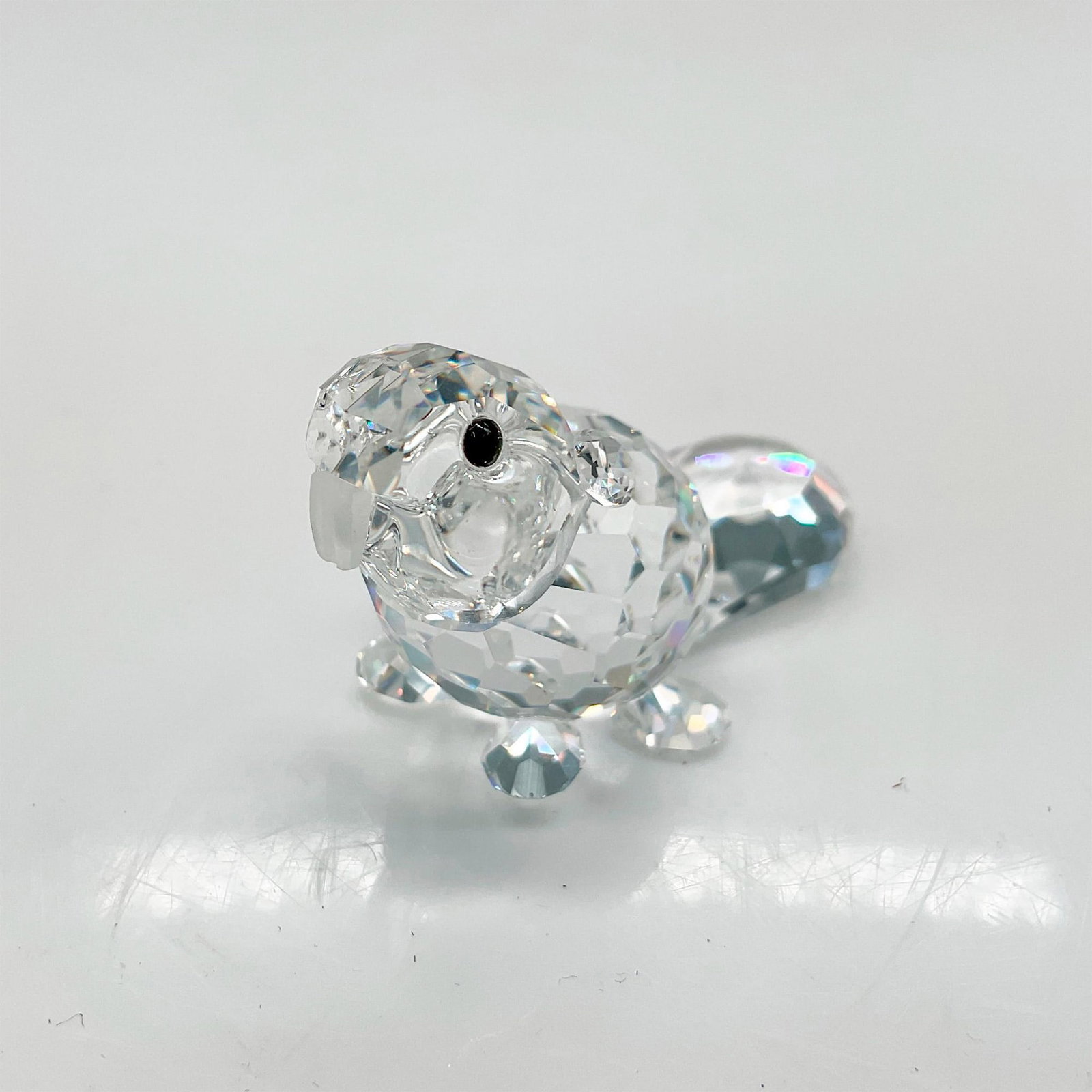 Swarovski Silver Crystal Figurine, Sitting Baby Beaver: Part of the Endangered species group. Sweet figural has crystal faceted body, tail and feet with satin crystal front teeth and jet crystal eyes. Swarovski backstamp. 7616 000 002. This item has its or