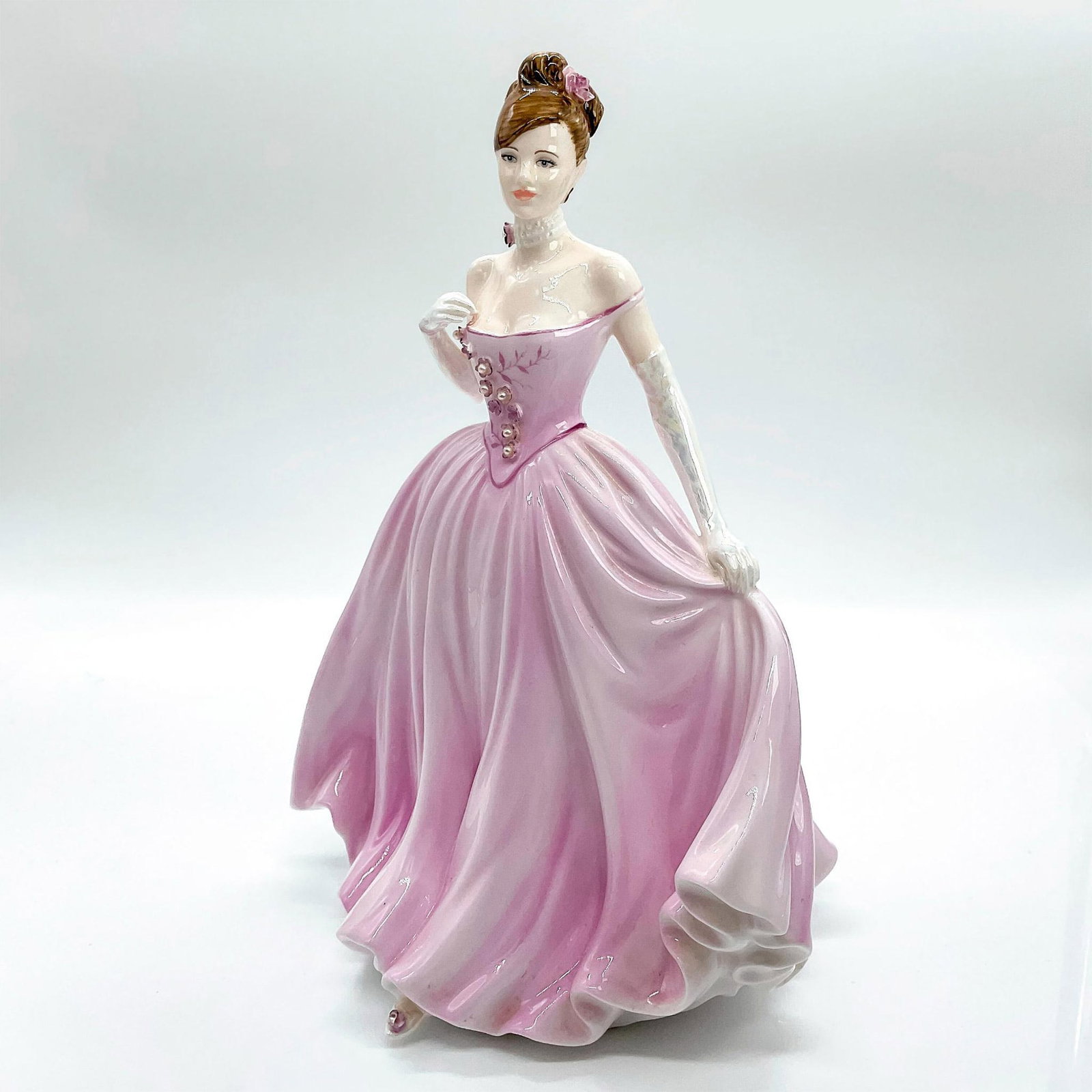 Coalport Figurine, The Rose Ball: Limited edition rare and precious bone china figure depicting beauty in a stunning soft pink strapless gown adorned with beautiful pearls; pearl necklace and shiny gloves. Coalport backstamp. This ite