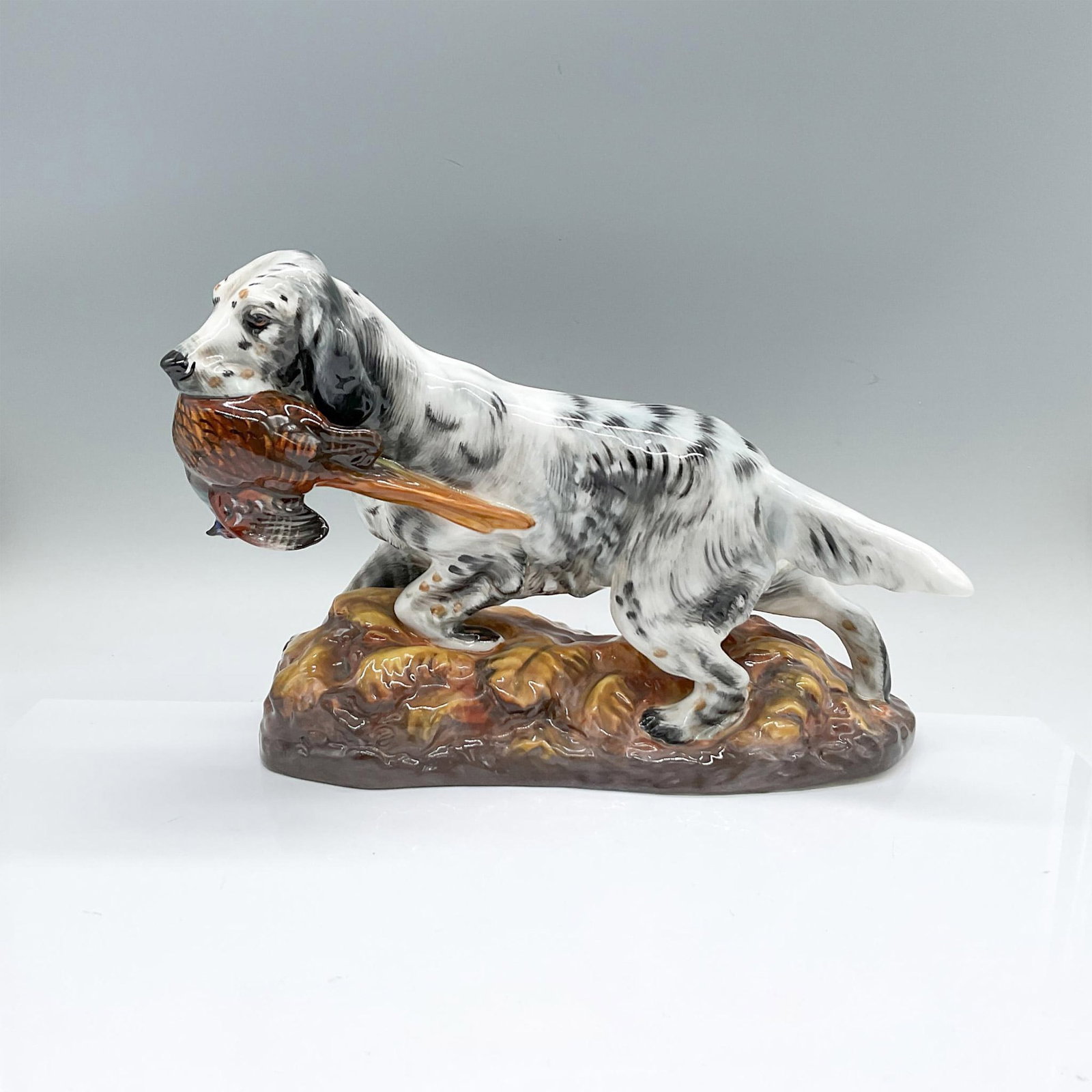 Royal Doulton Figurine, English Setter with Pheasant HN2529: Bone china glazed figure of a hunting dog with a gamebird. Royal Doulton backstamp. Artist: Frederick Daws Issued: c. 1939-1985 Dimensions: 11.25"L x 5"W x 8"H Manufacturer: Royal Doulton Country of