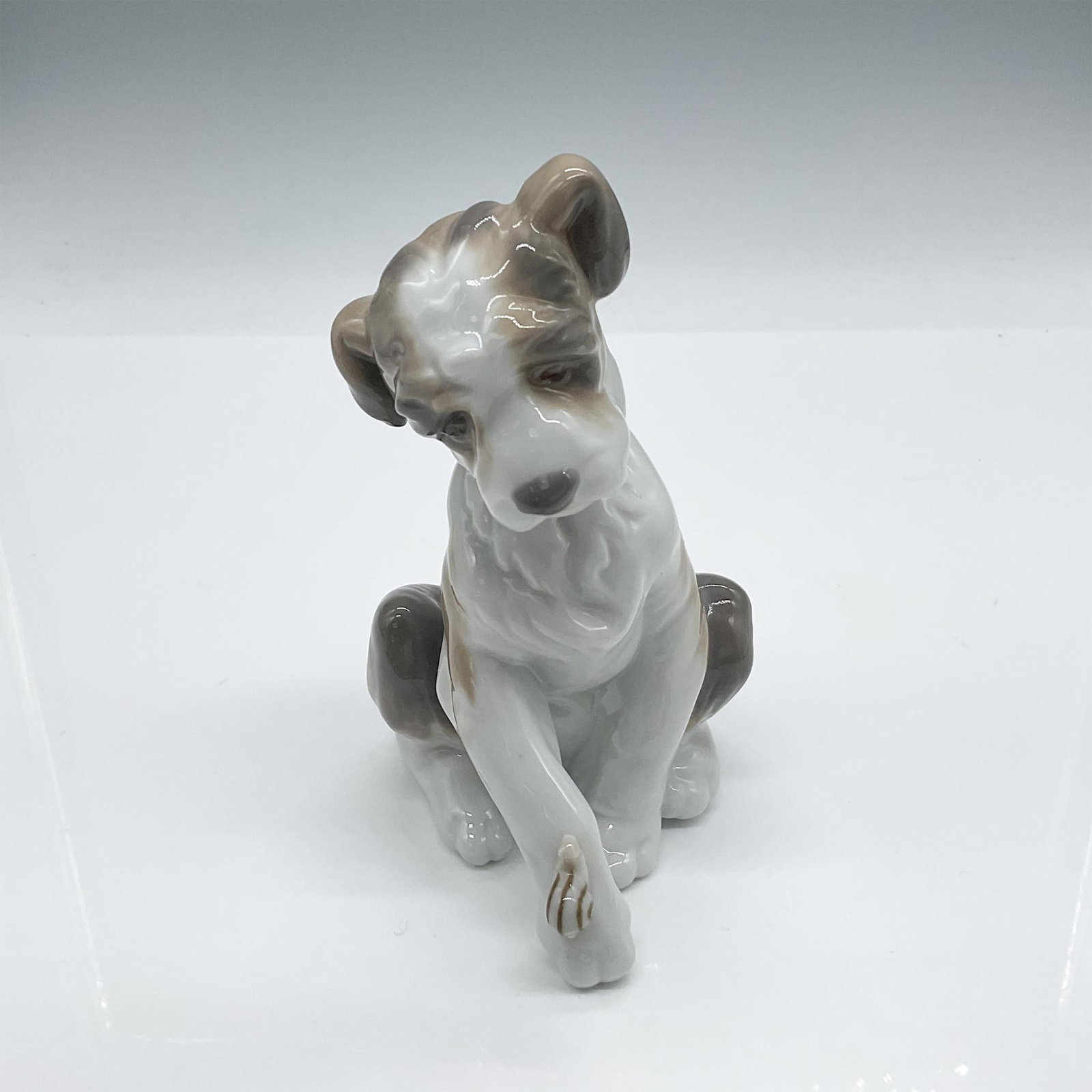 New Friend 1006211 - Lladro Porcelain Figurine: Cute little dog looks inquisitive as a little snail crawls up his leg. Glossy finish. Lladro backstamp. Artist: Juan Huerta Issued: 1995-2021 Dimensions: 4.50"L x 3"W x 5"H Manufacturer: Lladro Count