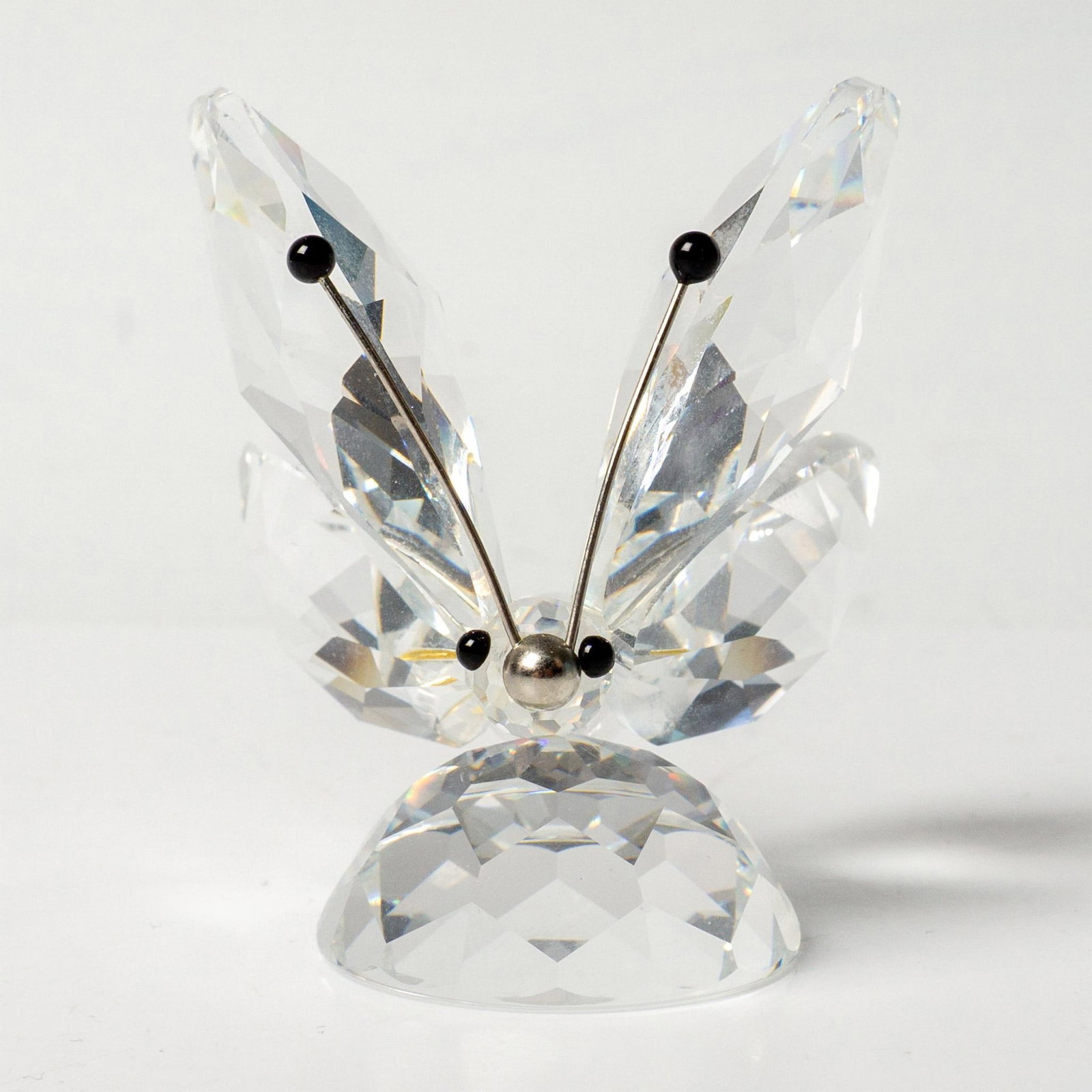 Swarovski Crystal Figurine, Butterfly: Brilliant clear faceted figure of a crystal butterfly with black tipped rhodium antennae, black eyes. Part of the In A Summer Meadow collection. Swarovski mark. Issued: 1982-2006 Dimensions: 2"L x 1.7
