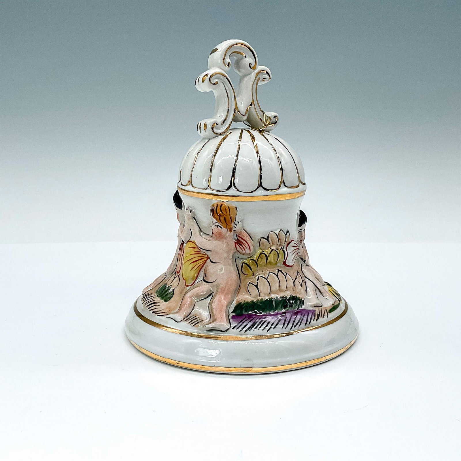 Vintage Capodimonte Style Porcelain Bell: Lovely Italian porcelain hand painted bell, decorated in high relief with a scene of children playing in the garden, gold filleted trims. Issued: 20th century Dimensions: 5"H x 4.5" dia.