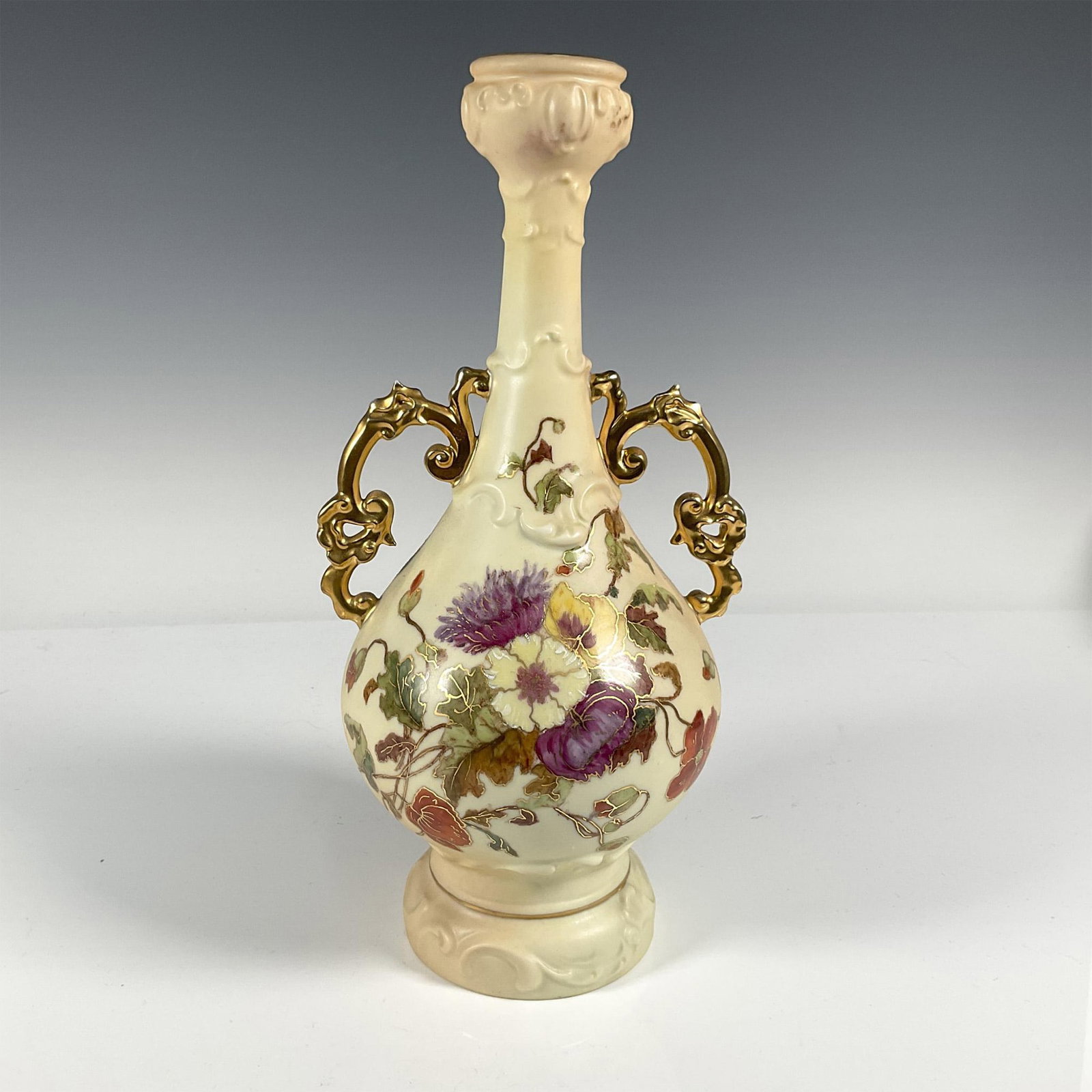 Rudolstadt Porcelain Bottle Vase: Hand painted porcelain vase with multi floral motif, gilded handles, rim, and trim detail. Backstamp Germany RW Rudolstadt in blue Issued: 20th century Dimensions: 12"H x 5.5"dia Manufacturer: Rudolst