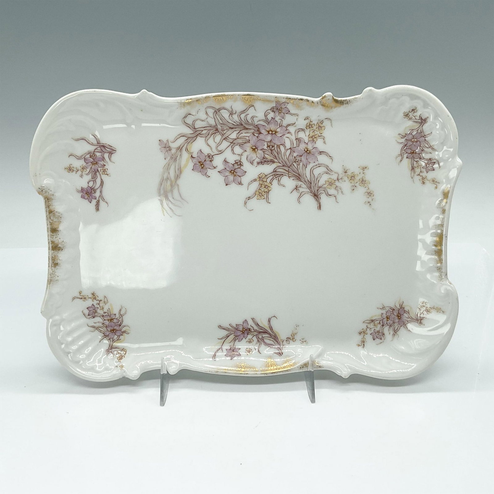 Elite BM Limoges France Porcelain Tray, Floral Motif: Beautiful white tray adorned with lavender-colored flowers and delicate gold accents, featuring ornate decorative edges. Elite BM Limoges, France backstamp. Issued: 20th century Dimensions: 9"L x 6.5"